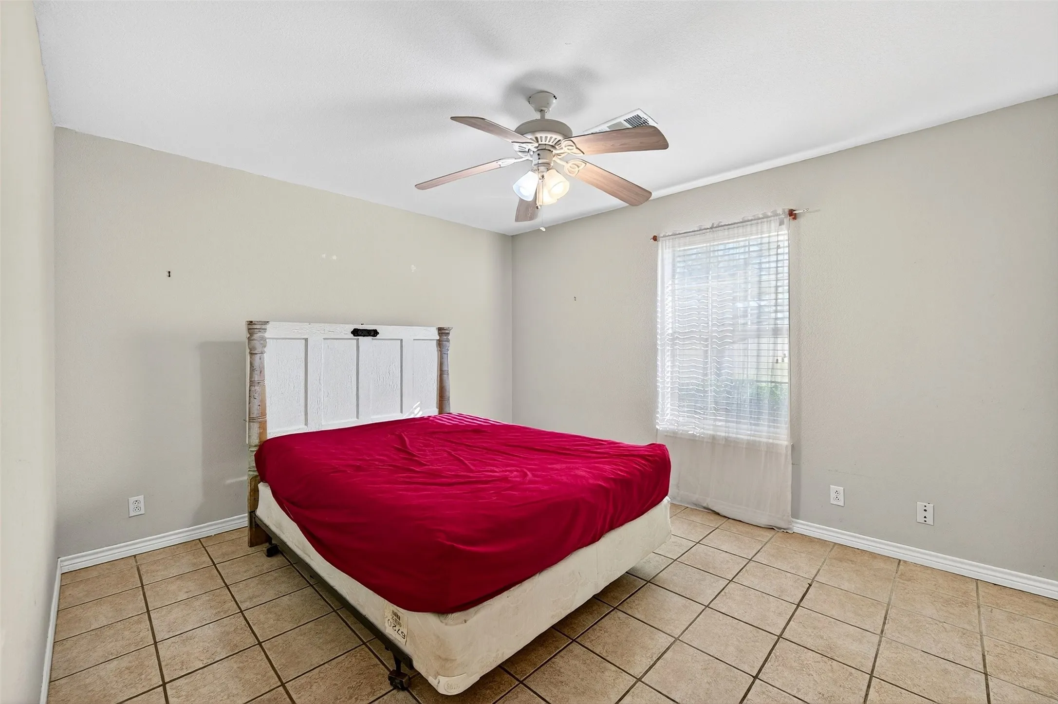 Bedroom featuring ceiling fan and light tile patterned flooring