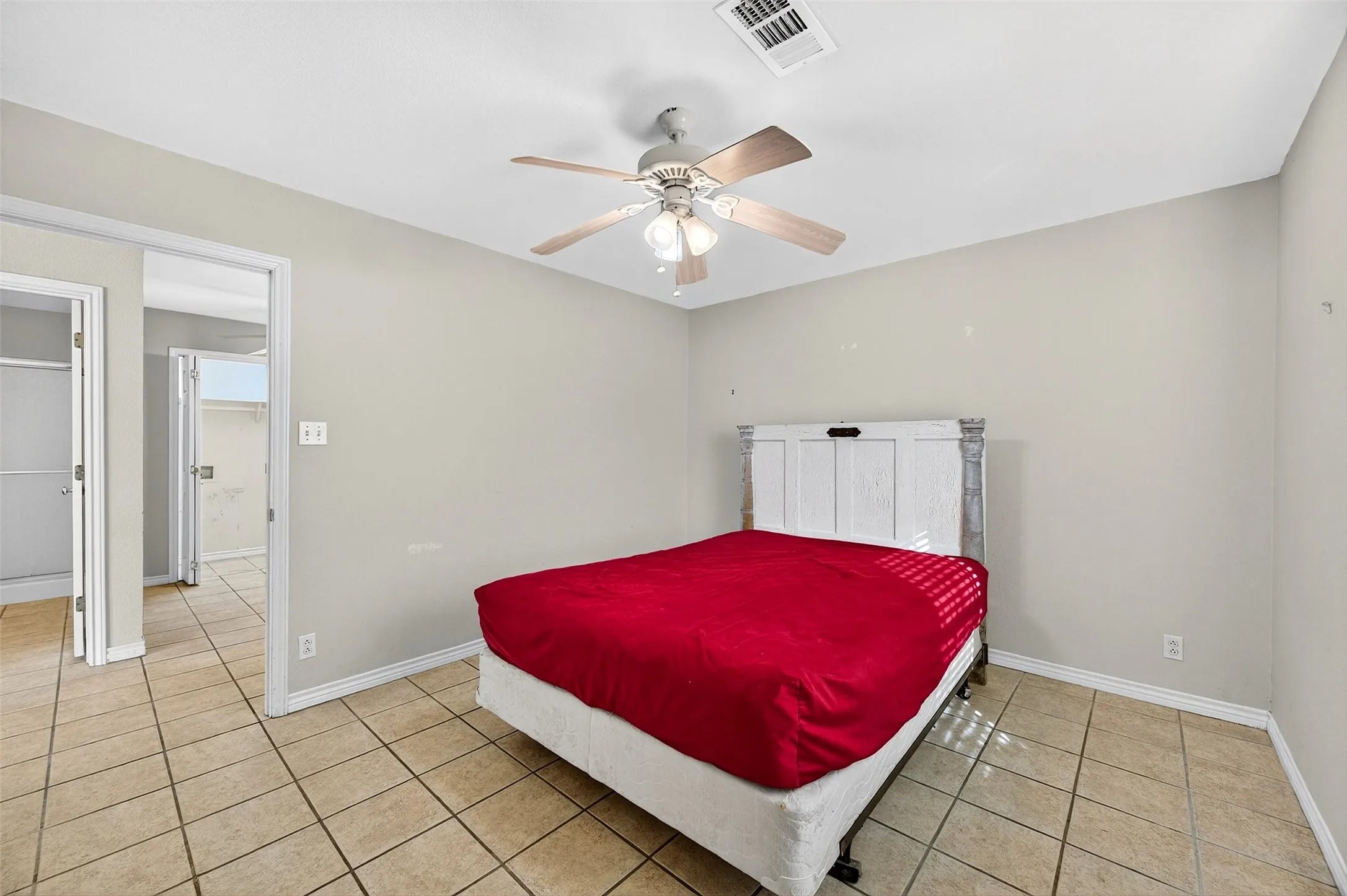 Bedroom featuring light tile patterned floors and a ceiling fan