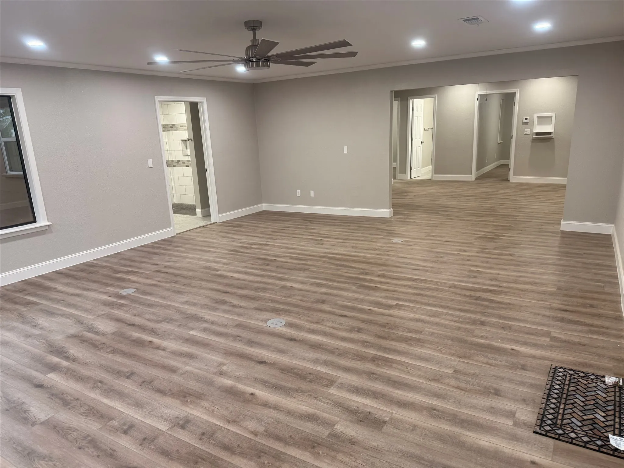 Empty room featuring recessed lighting, light wood-style floors, ornamental molding, and a ceiling fan