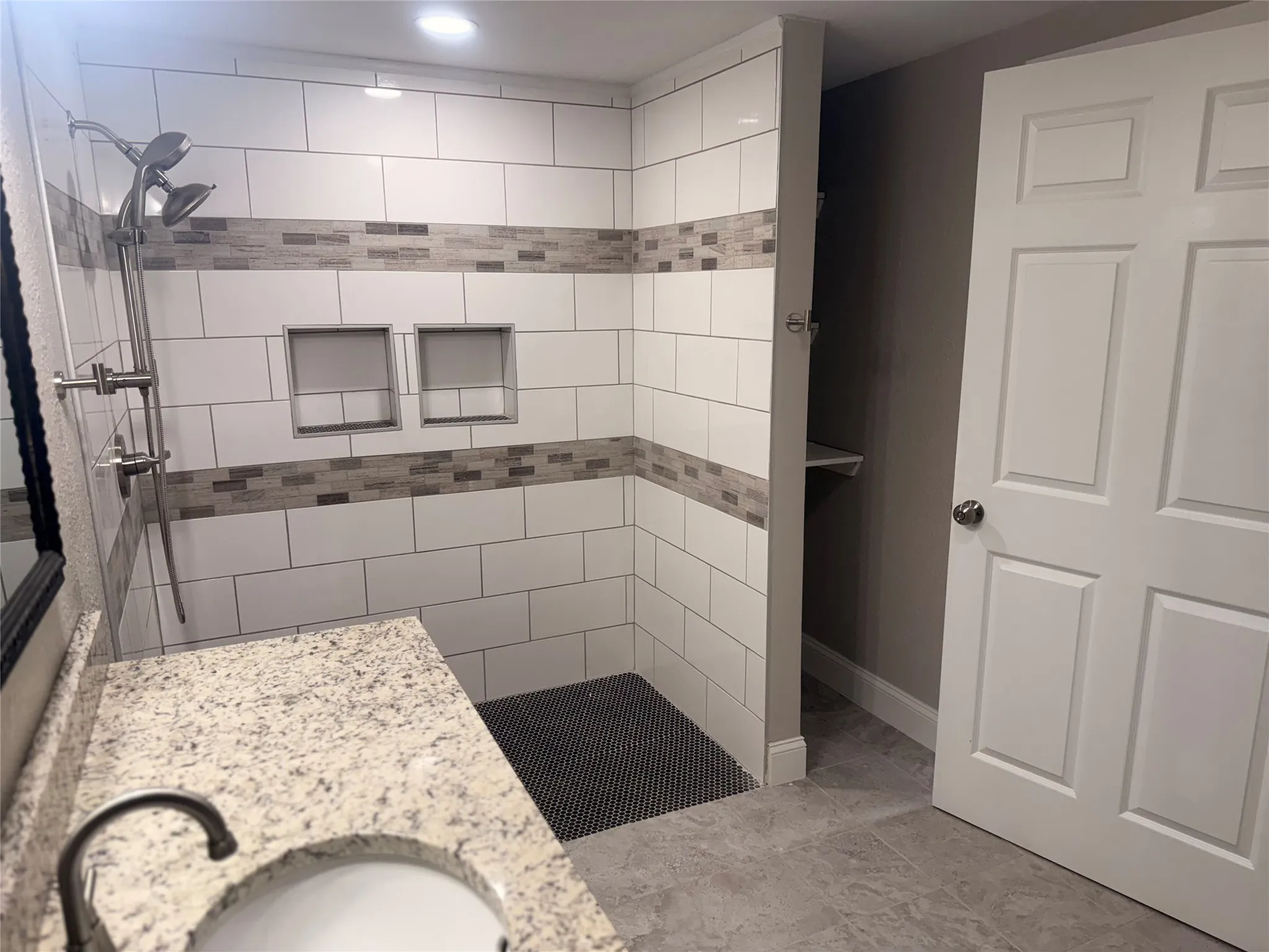 Full bath with a shower stall and a sink