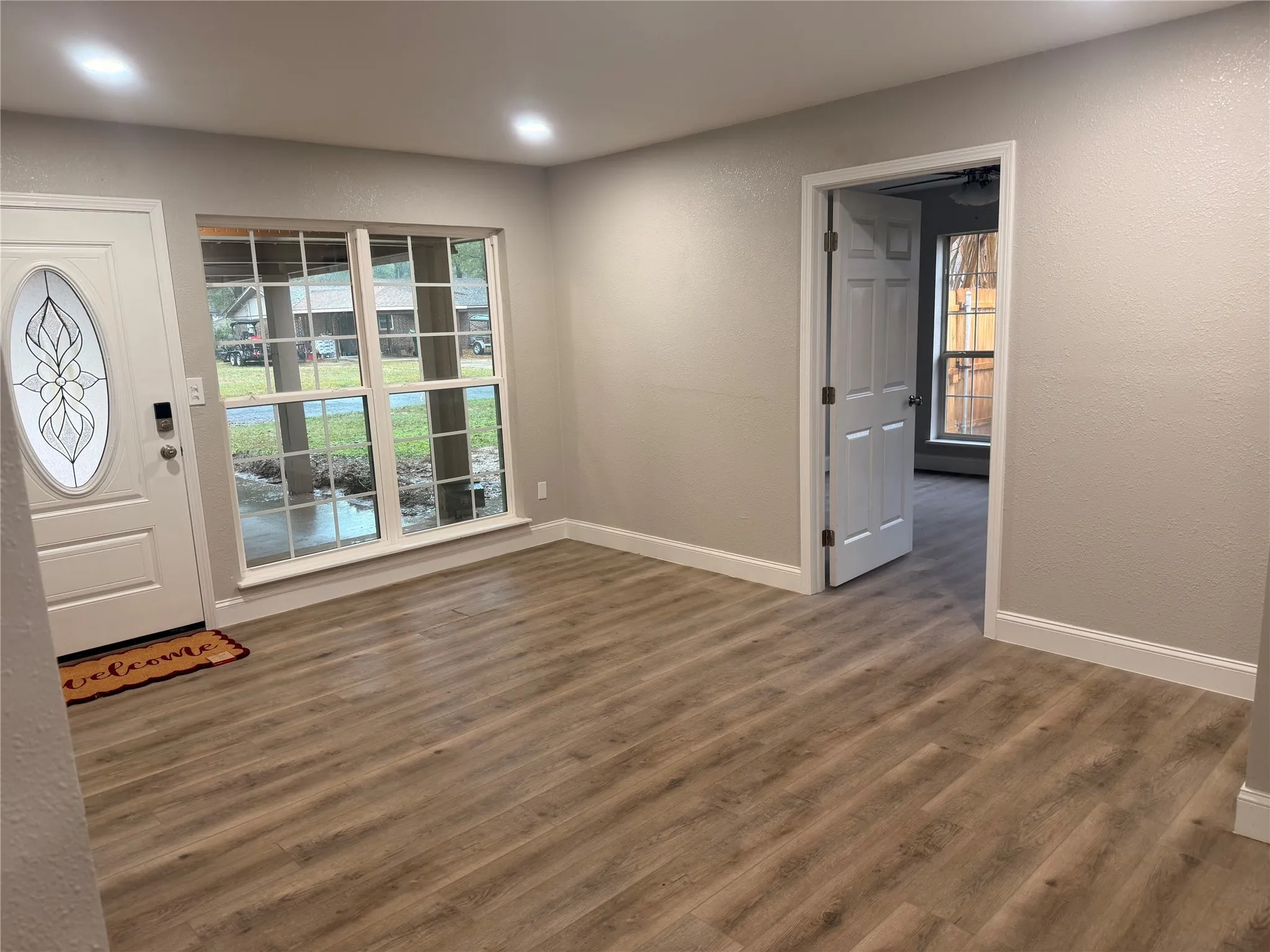 Entryway with dark wood finished floors and a textured wall