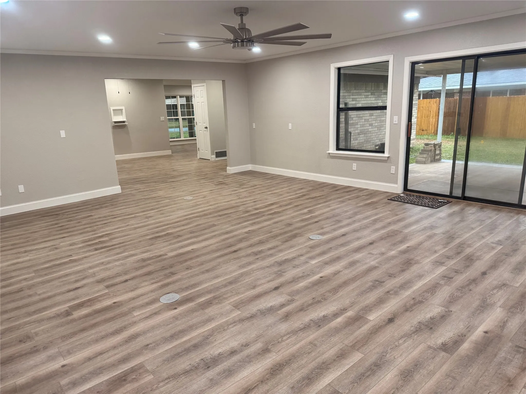 Spare room with recessed lighting, crown molding, light wood-style flooring, a ceiling fan, and plenty of natural light