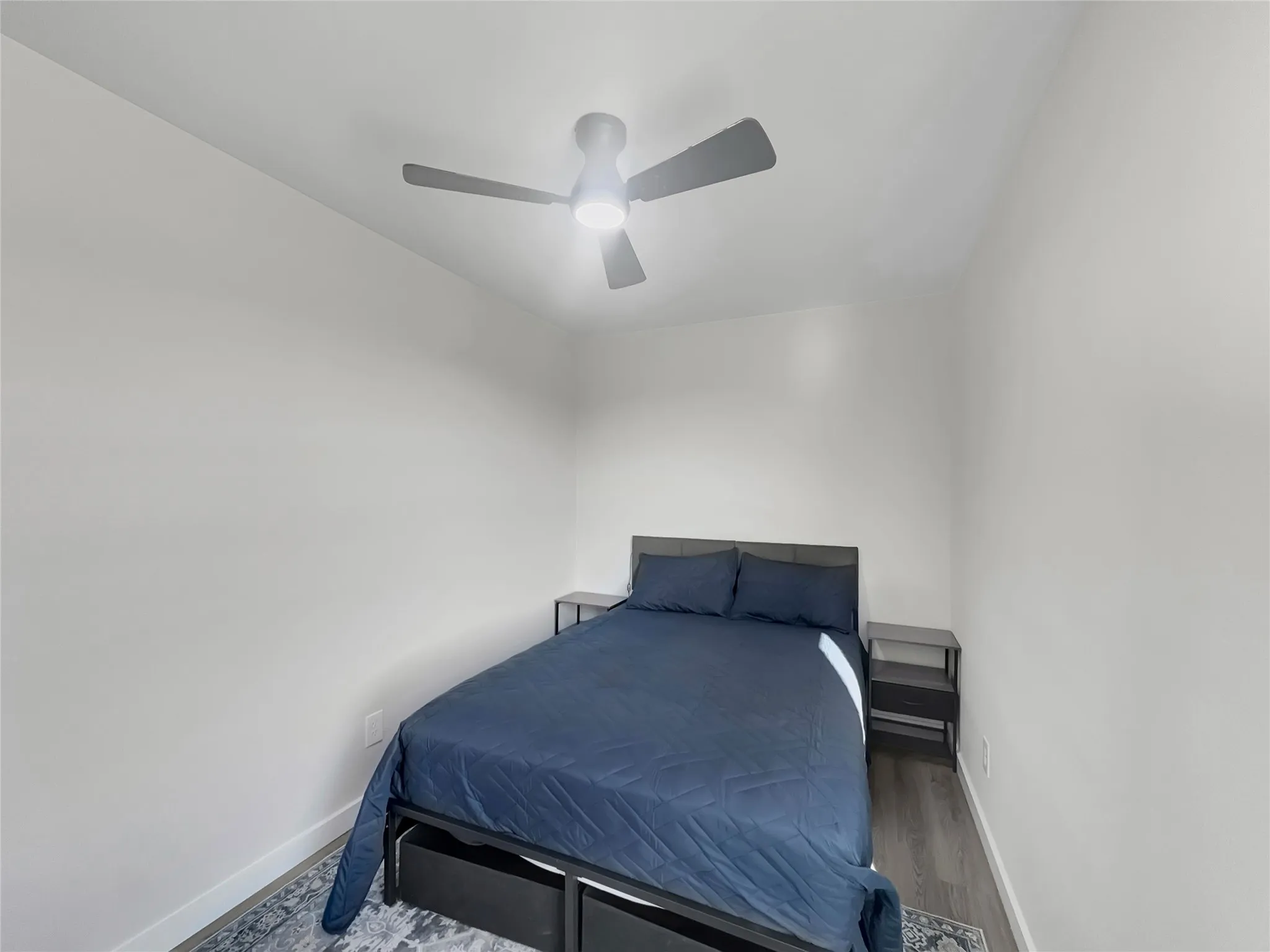 Bedroom featuring wood finishd floors and ceiling fan