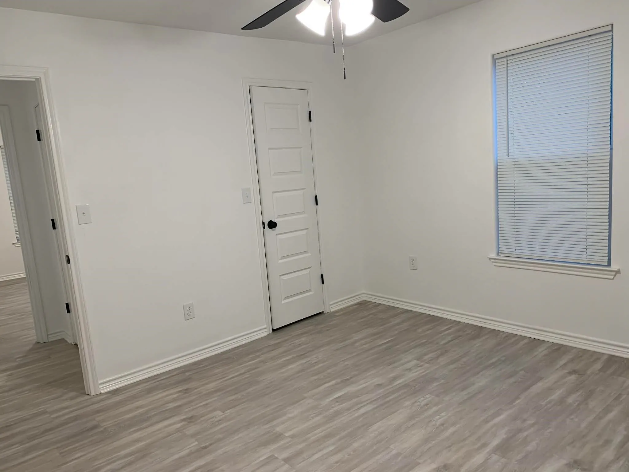 Spare room featuring light wood-type flooring and ceiling fan