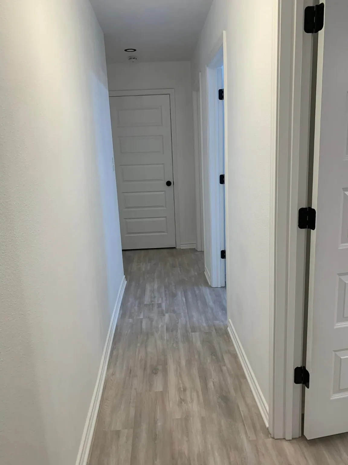 Hallway with light wood finished floors and baseboards
