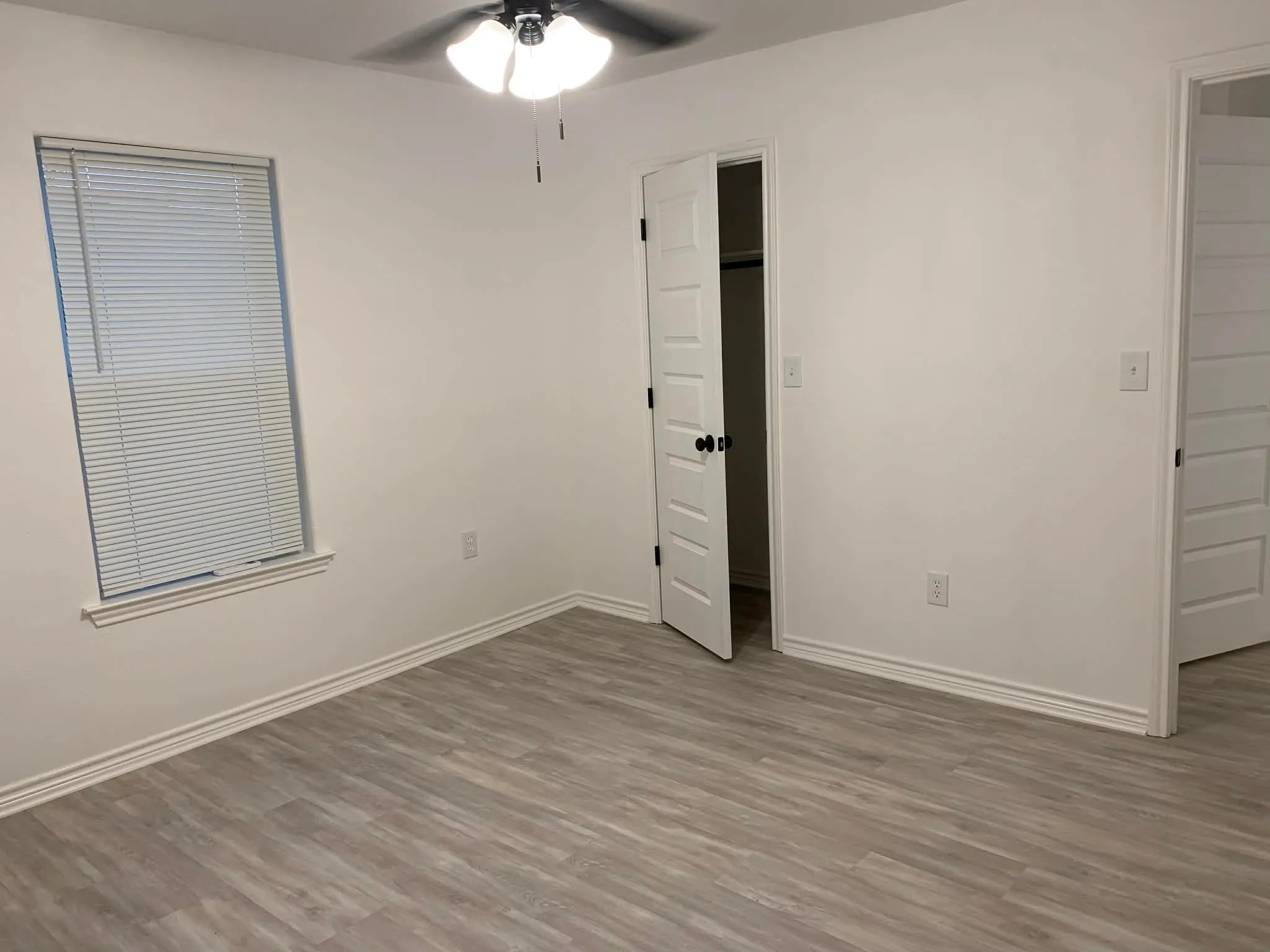 Unfurnished bedroom with wood finished floors and ceiling fan