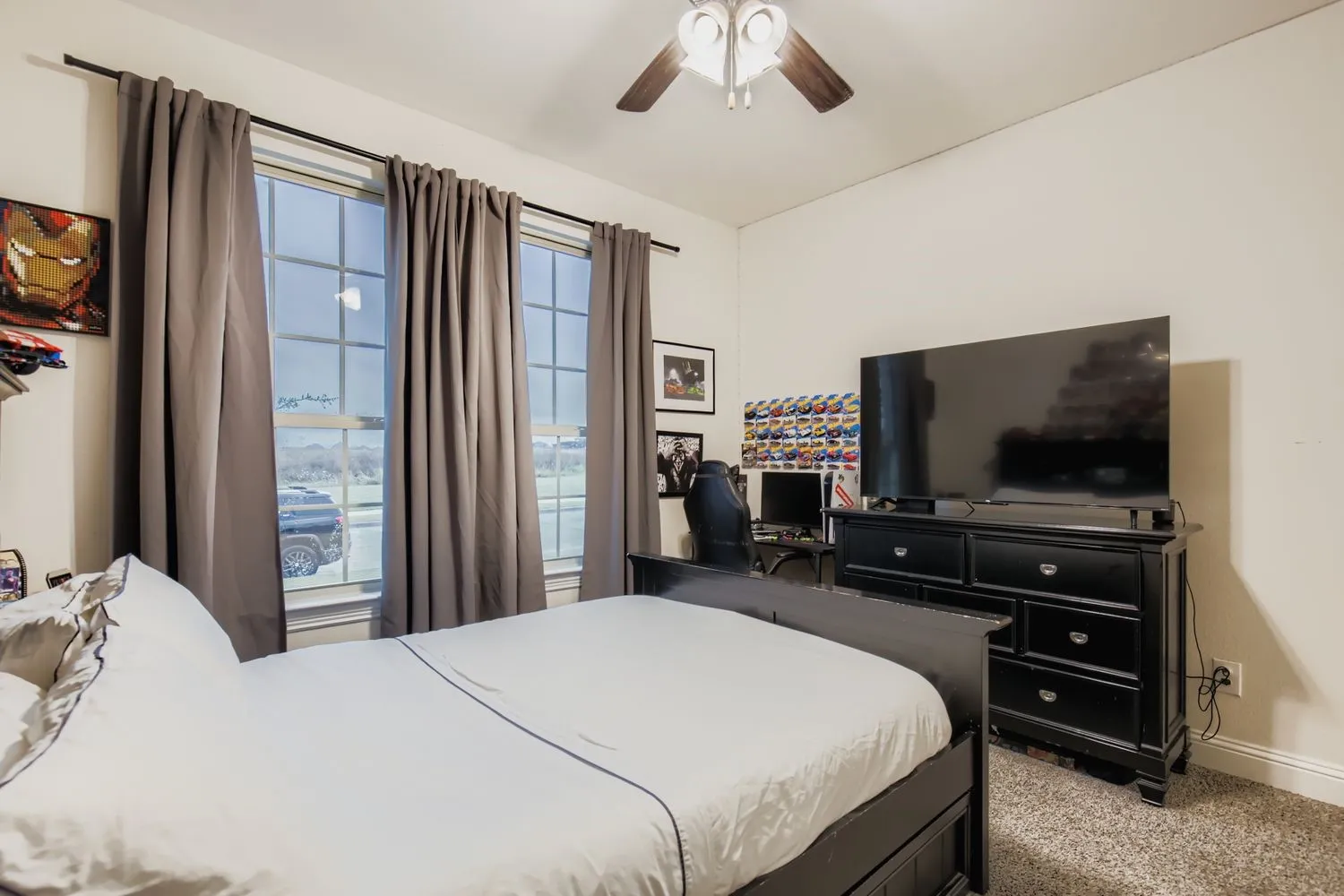 Bedroom featuring light colored carpet and a ceiling fan
