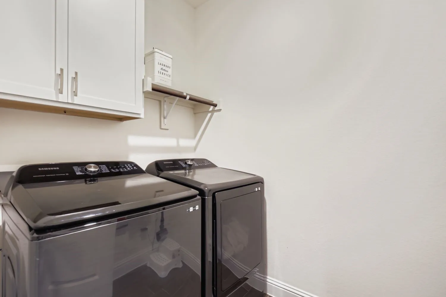 Laundry area with washer and clothes dryer and cabinet space