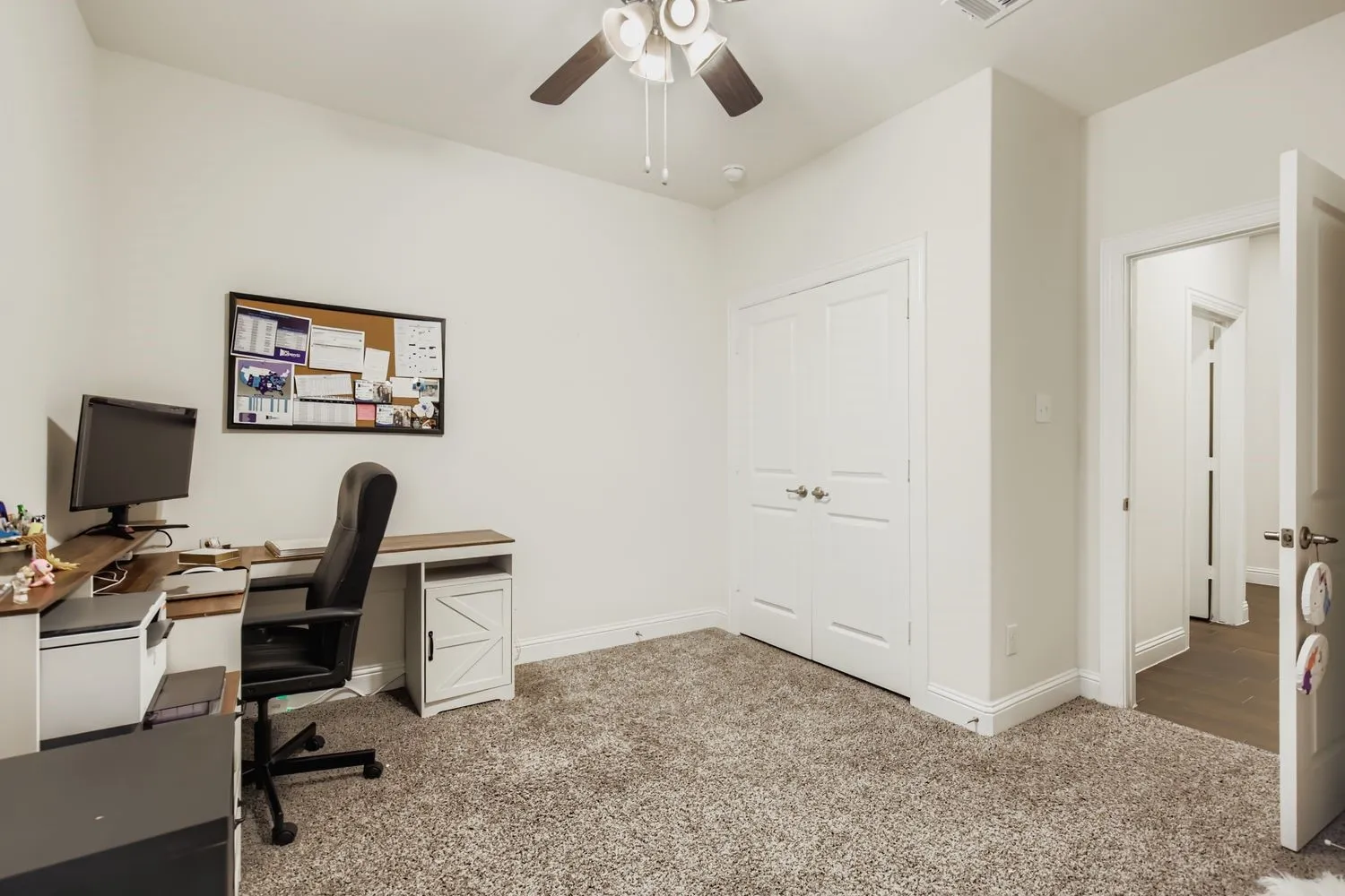 Office featuring light colored carpet and a ceiling fan