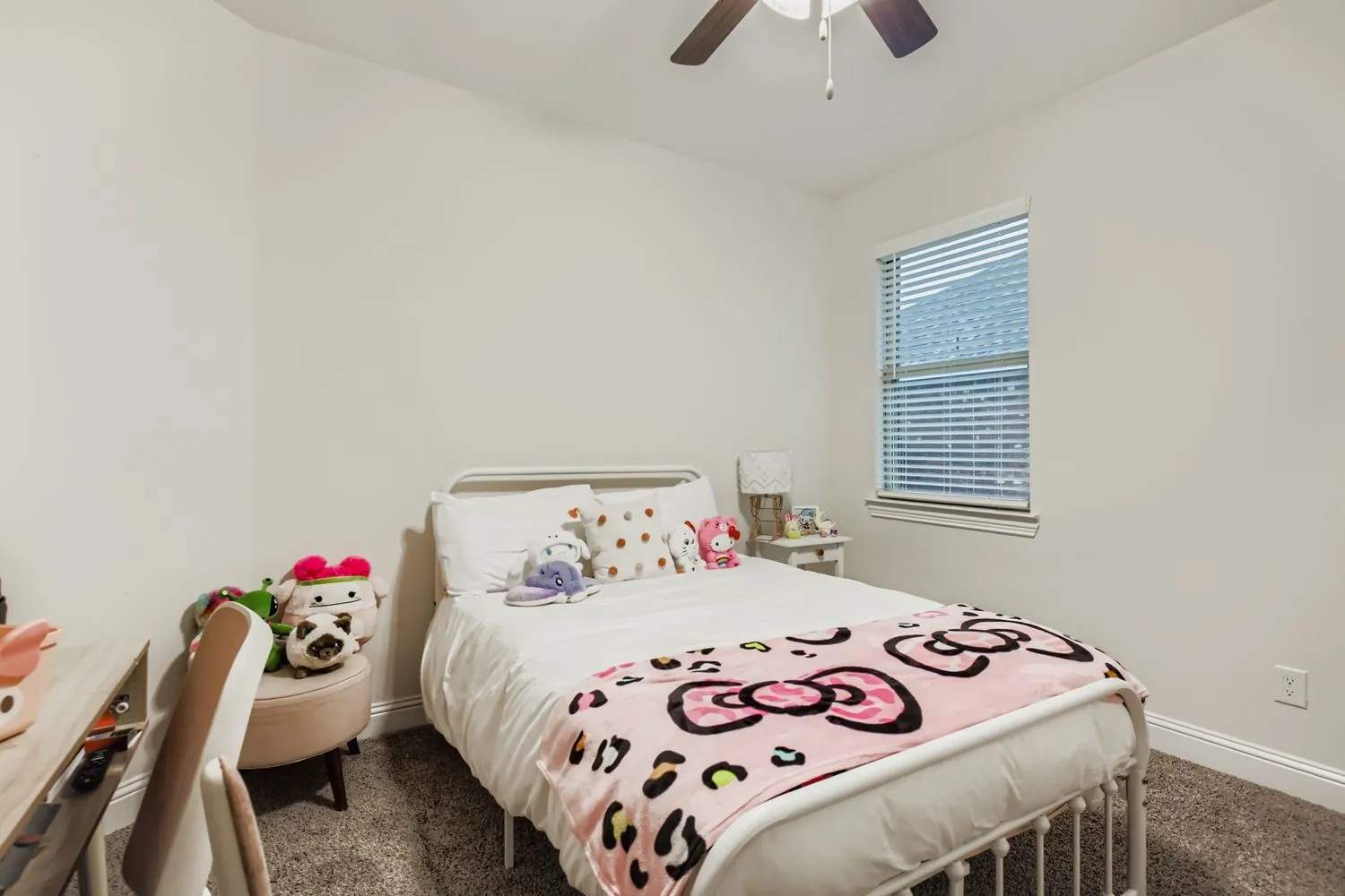 Bedroom with a ceiling fan and dark colored carpet