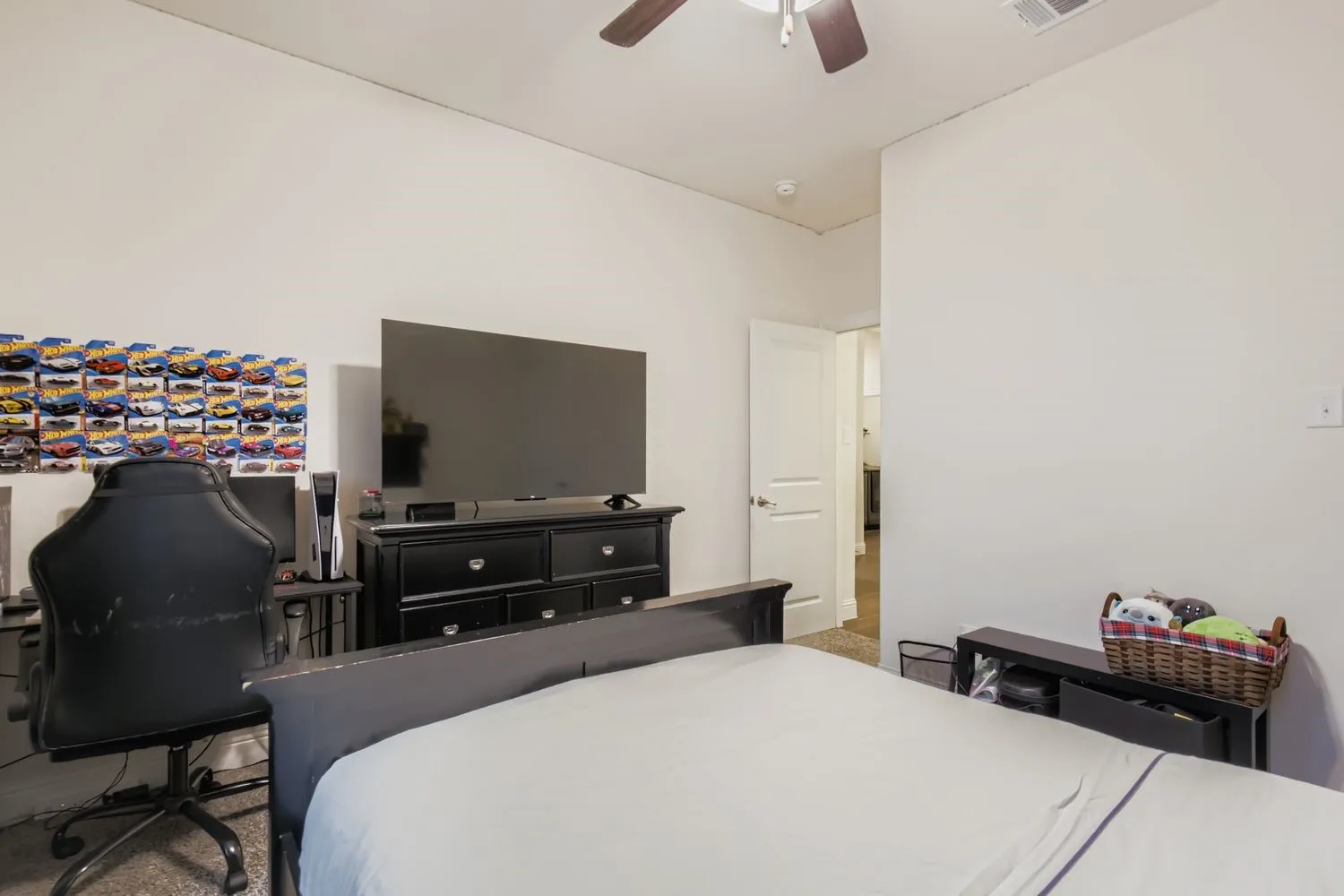 Bedroom featuring ceiling fan, a desk, and carpet flooring