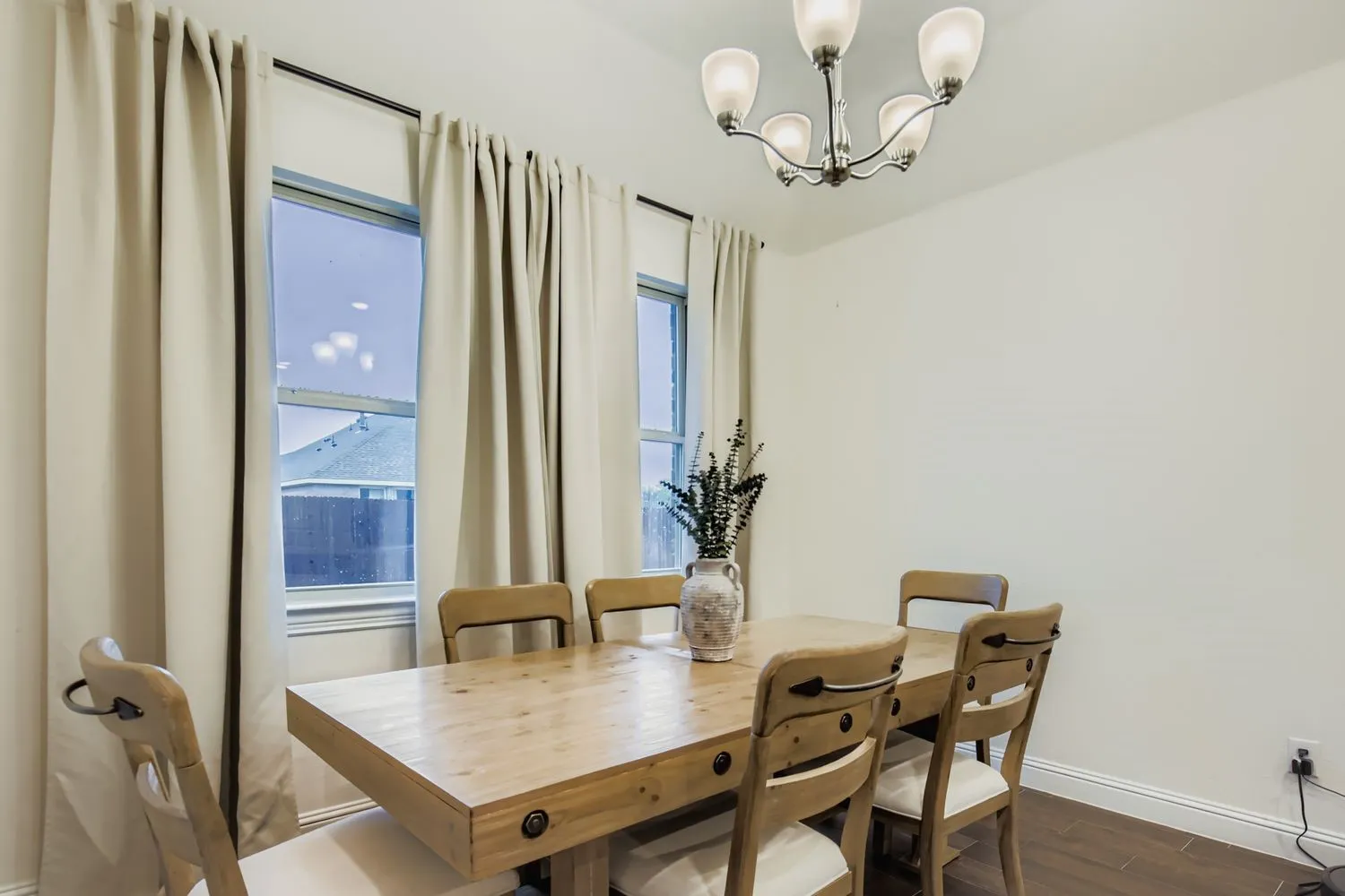 Dining room with a chandelier and dark wood-type flooring