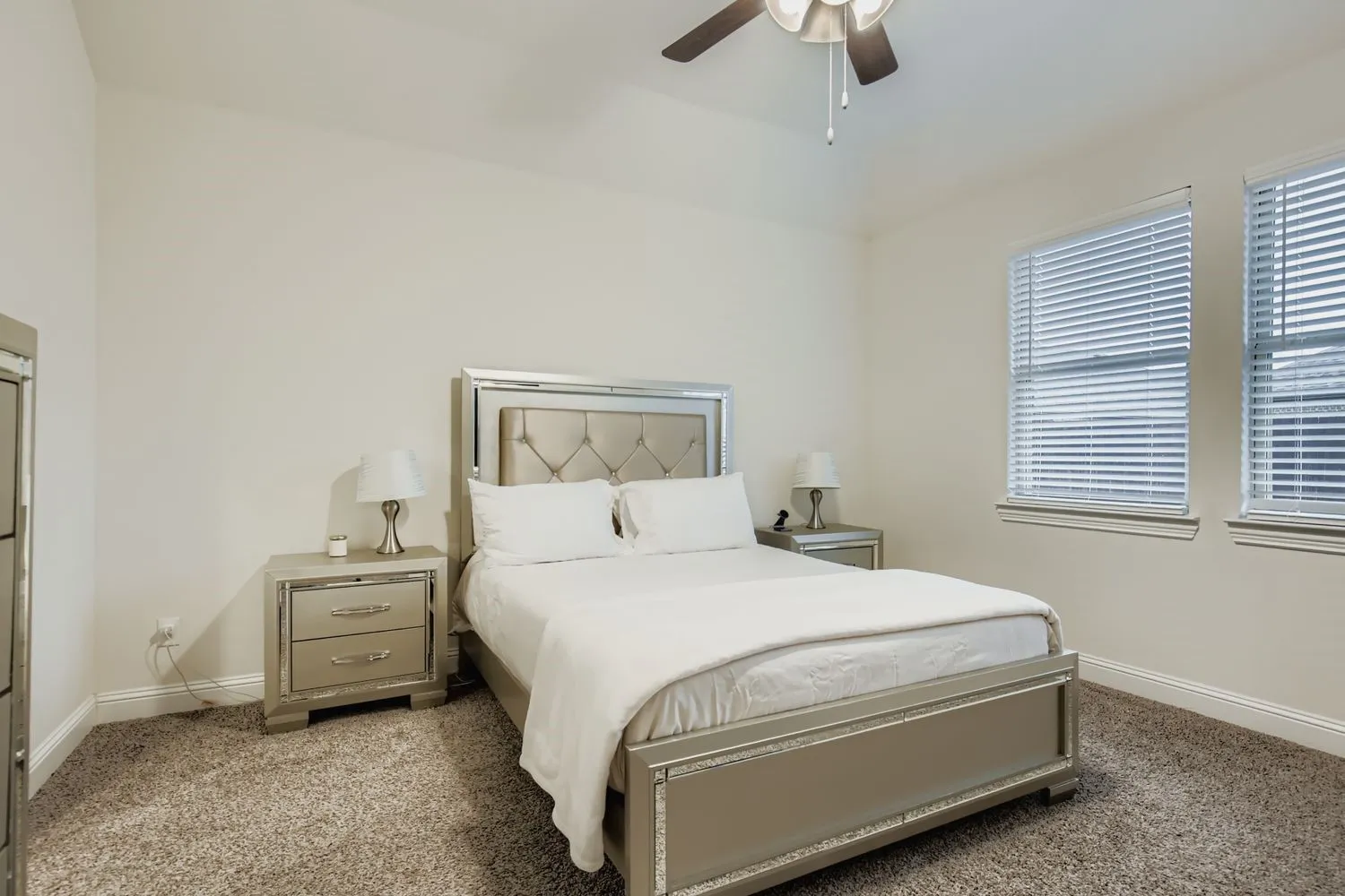 Bedroom with light carpet and ceiling fan