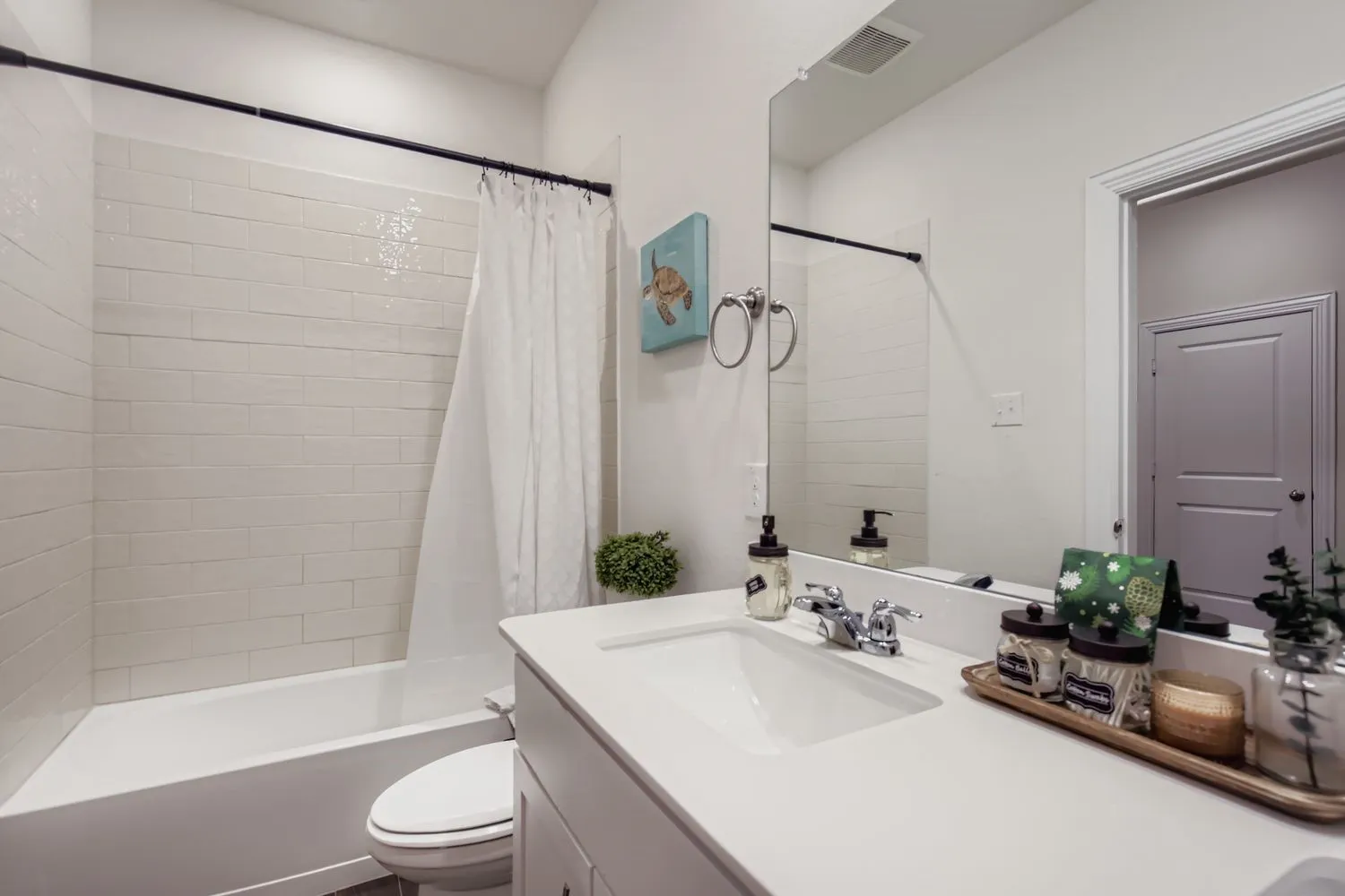 Bathroom with vanity and shower / bath combo with shower curtain