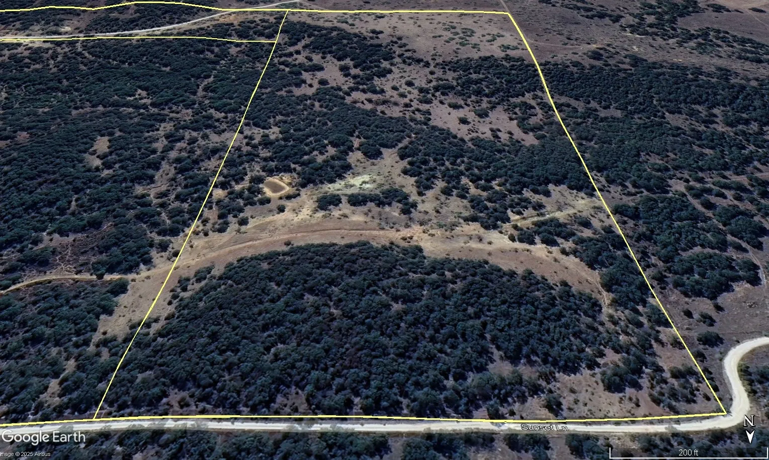 Aerial view of sparsely populated area featuring property boundaries highlighted
