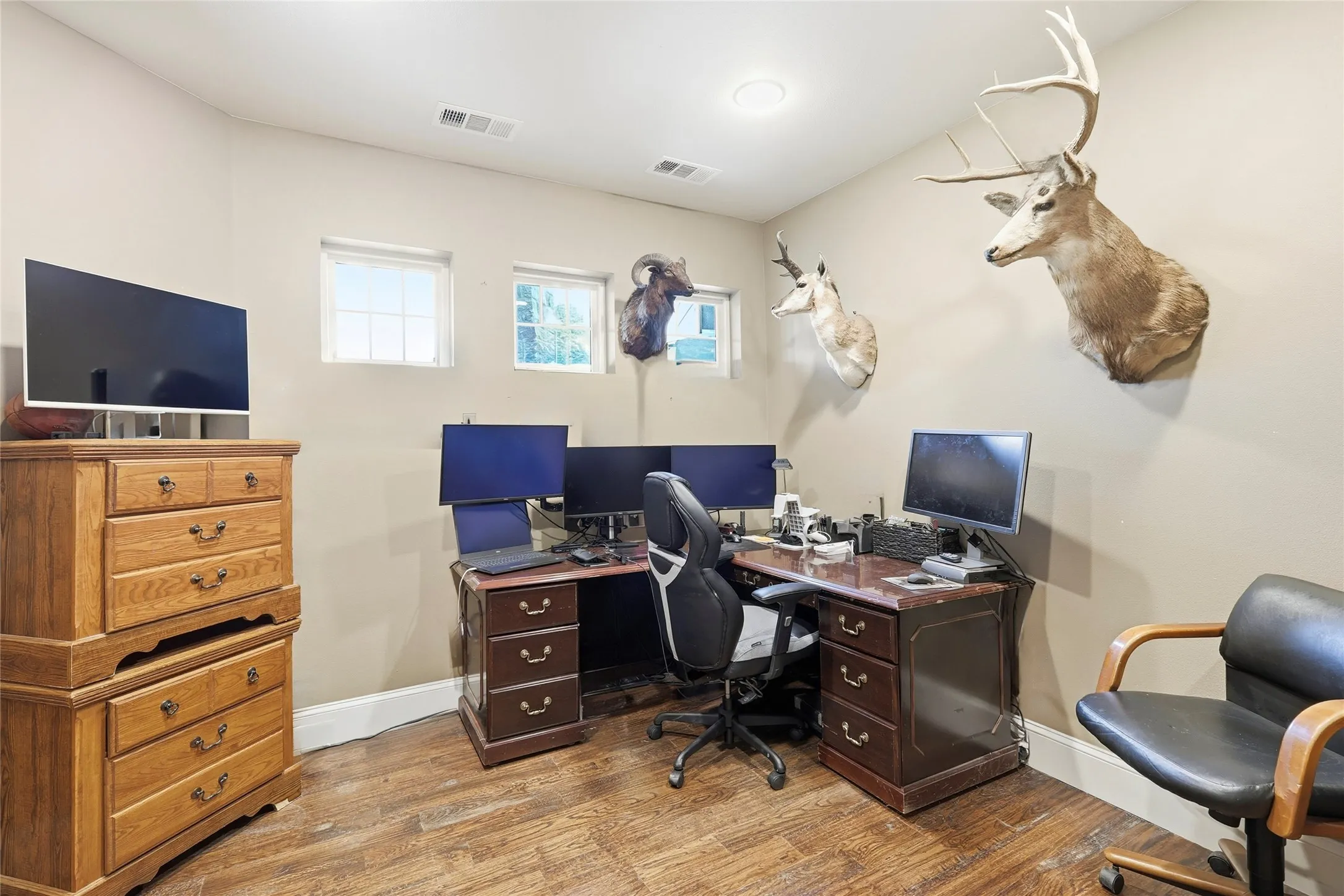 Office area featuring baseboards and light wood-style flooring