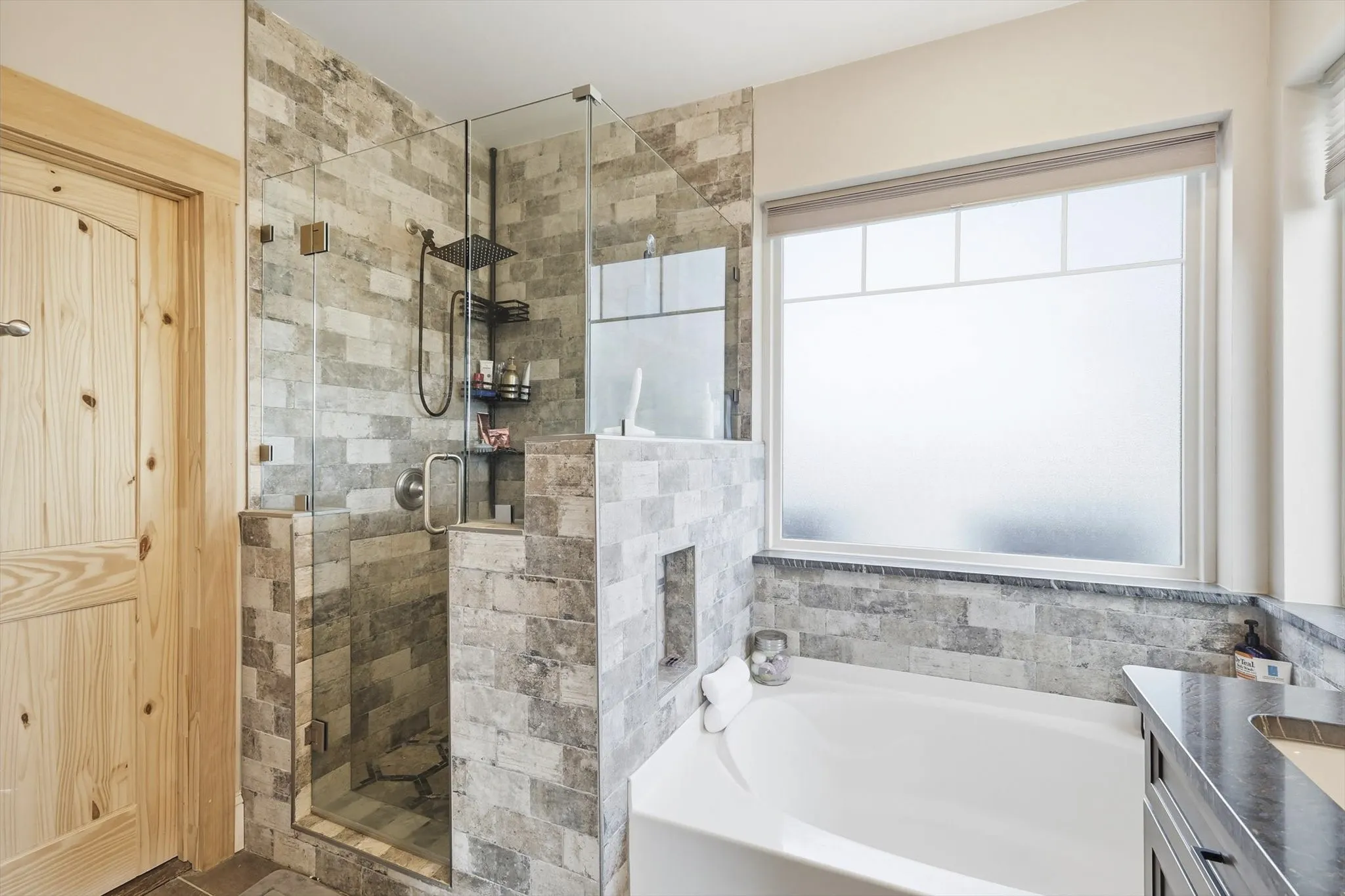 Bathroom featuring a bath, a stall shower, and vanity