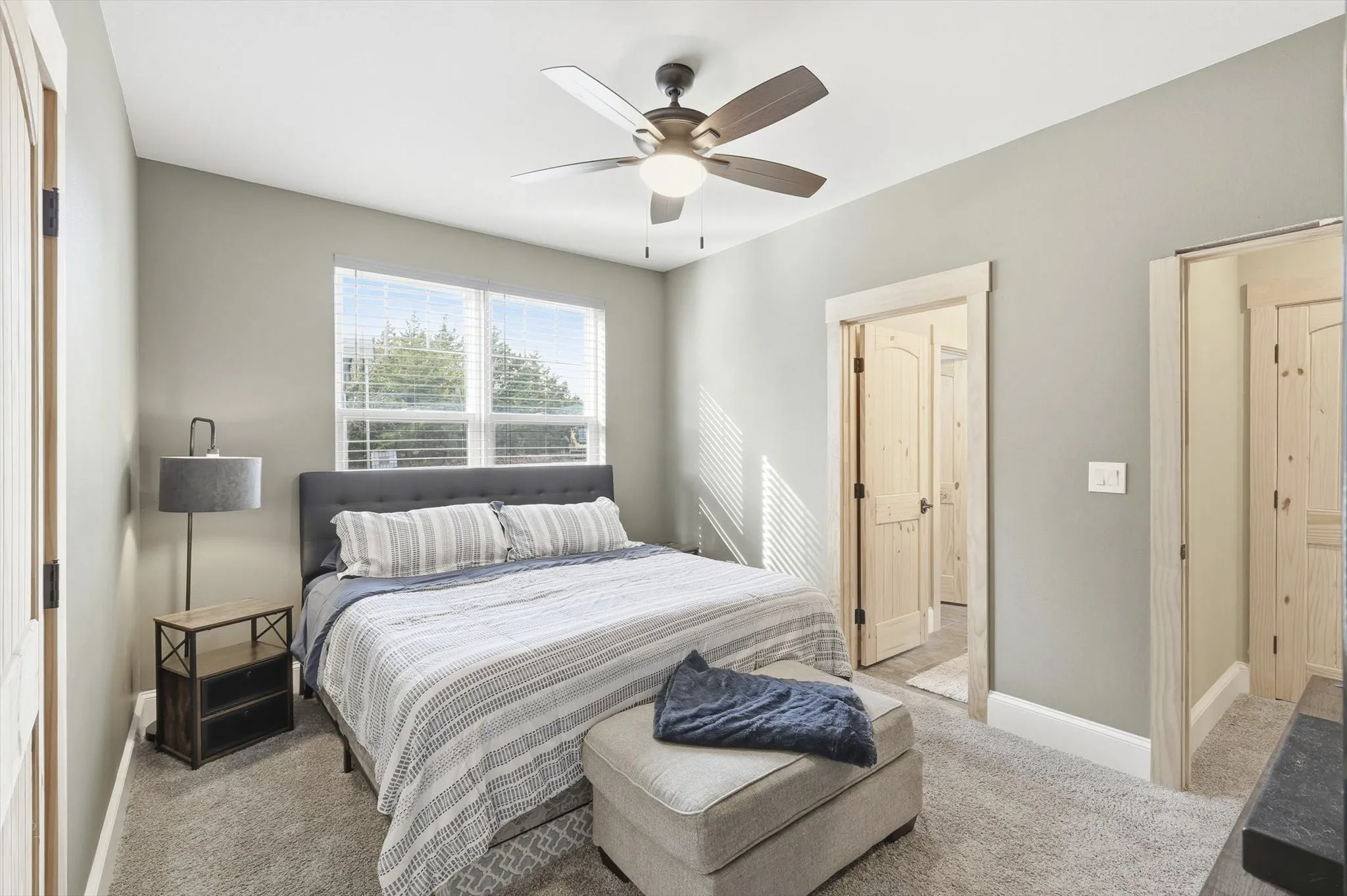 Bedroom with light colored carpet and ceiling fan