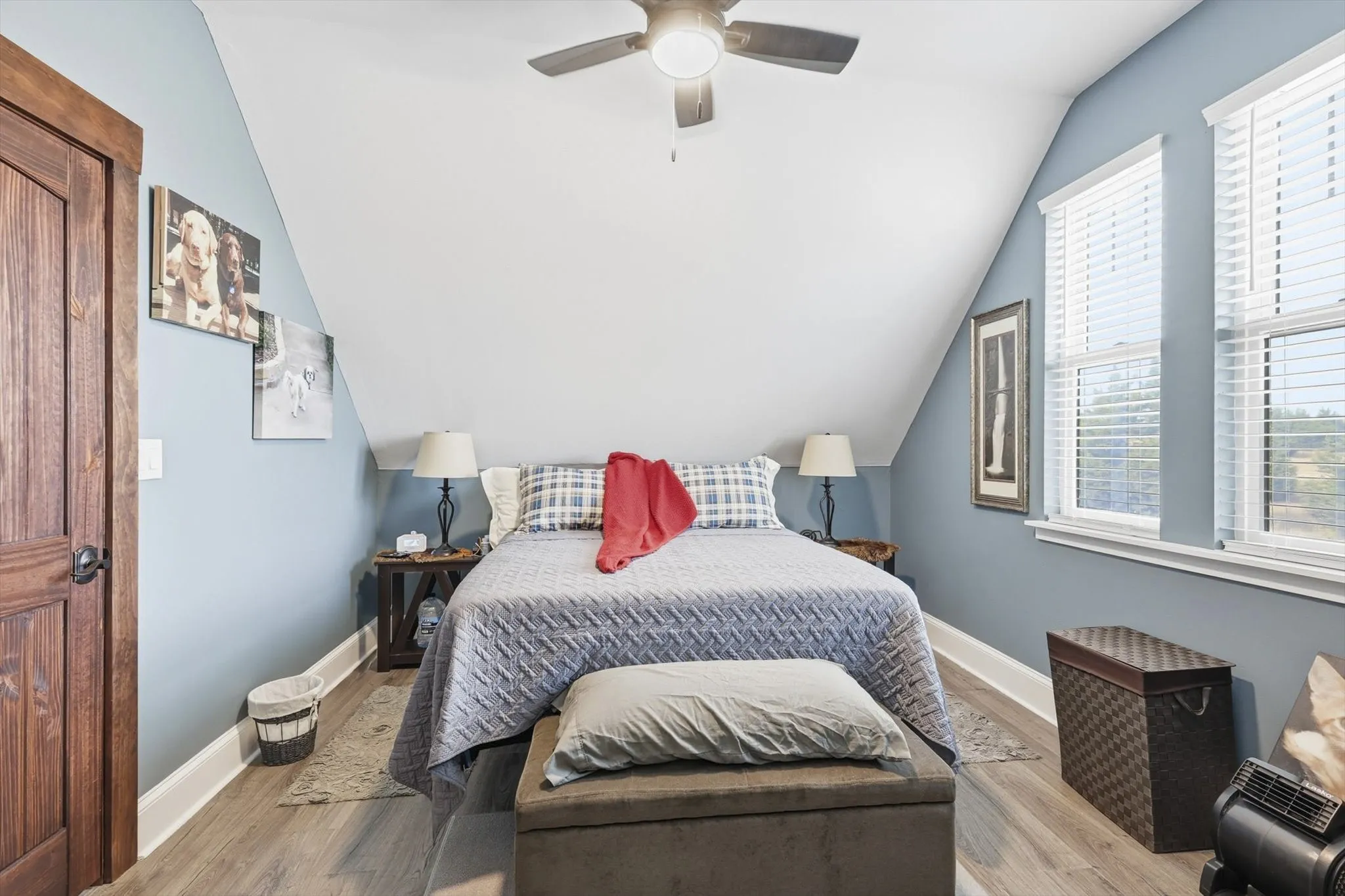 Bedroom with wood finished floors, lofted ceiling, and ceiling fan