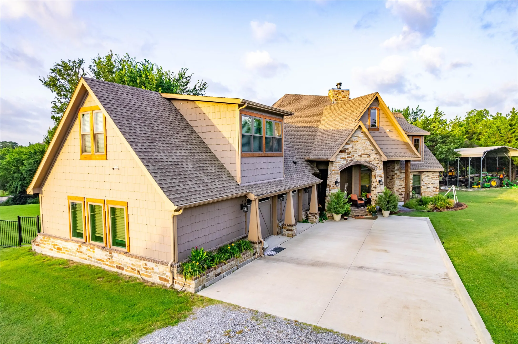 Craftsman-style exterior featuring a stone facade, shingle siding, and a covered entry porch