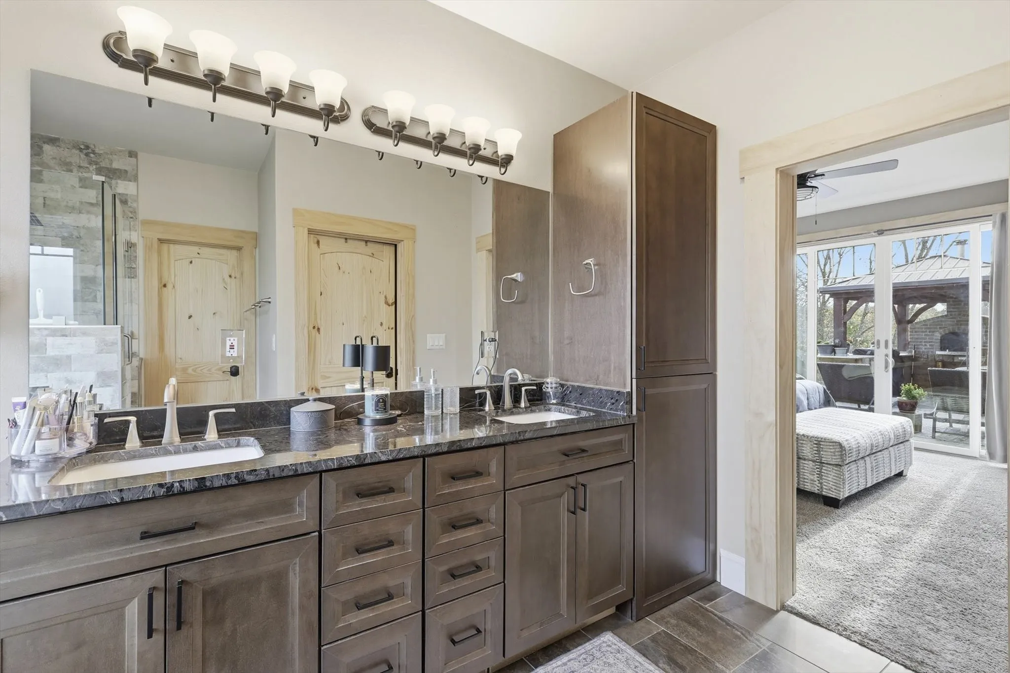 Ensuite bathroom with double vanity, ceiling fan, and wood finish floors