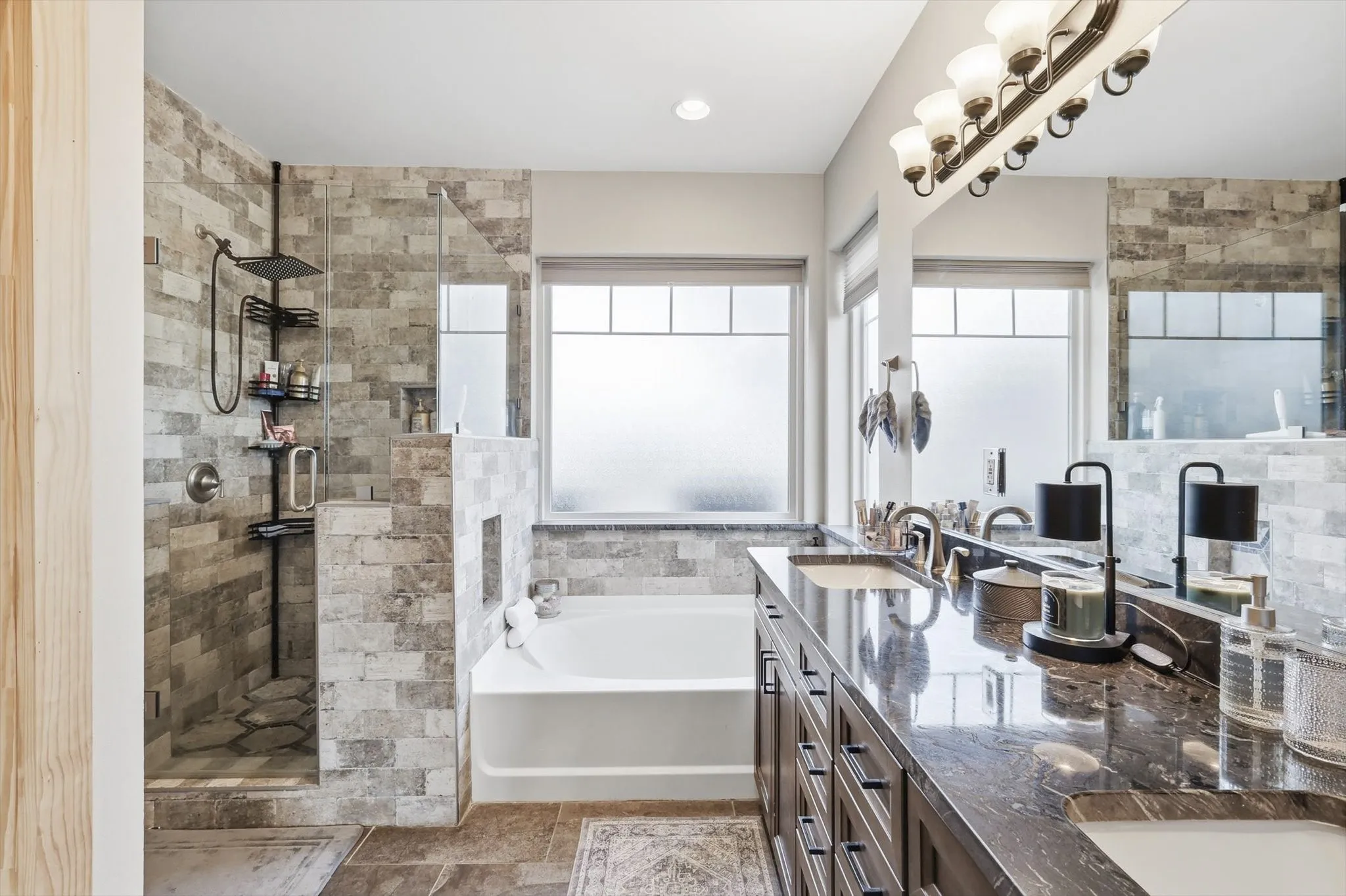 Full bathroom with a garden tub, double vanity, and a stall shower