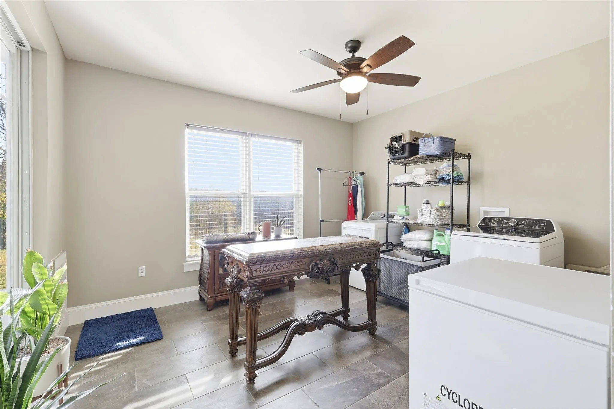 Home office featuring separate washer and dryer and ceiling fan
