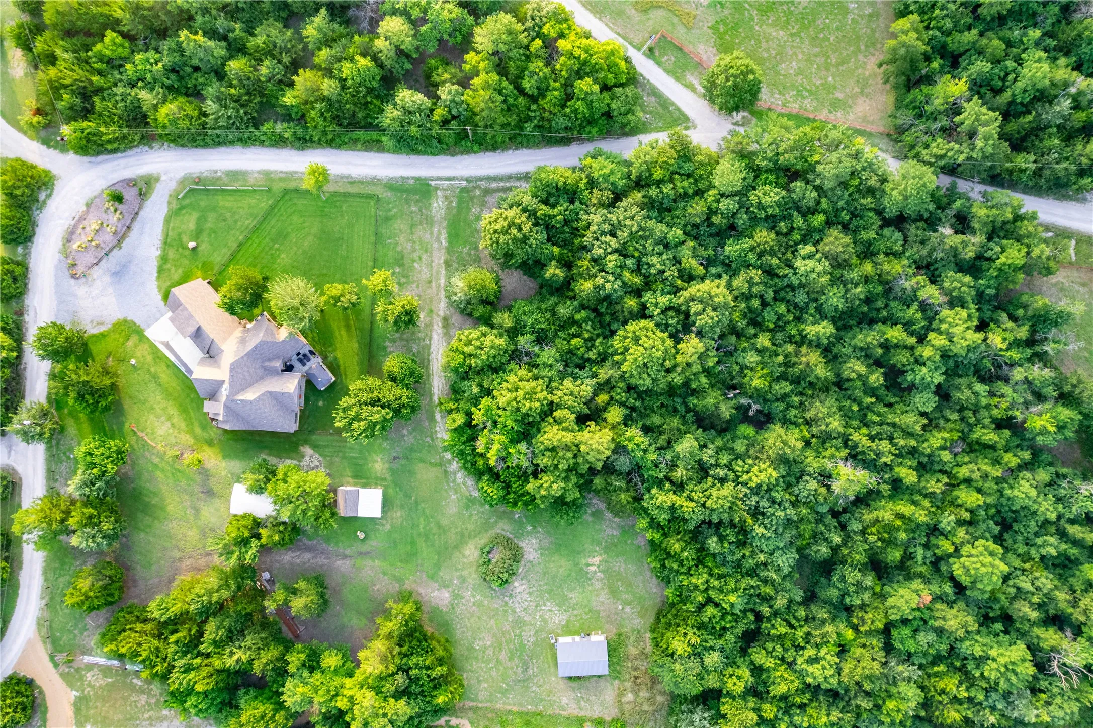 Aerial perspective highlighting a multi-story residence with a gabled roof