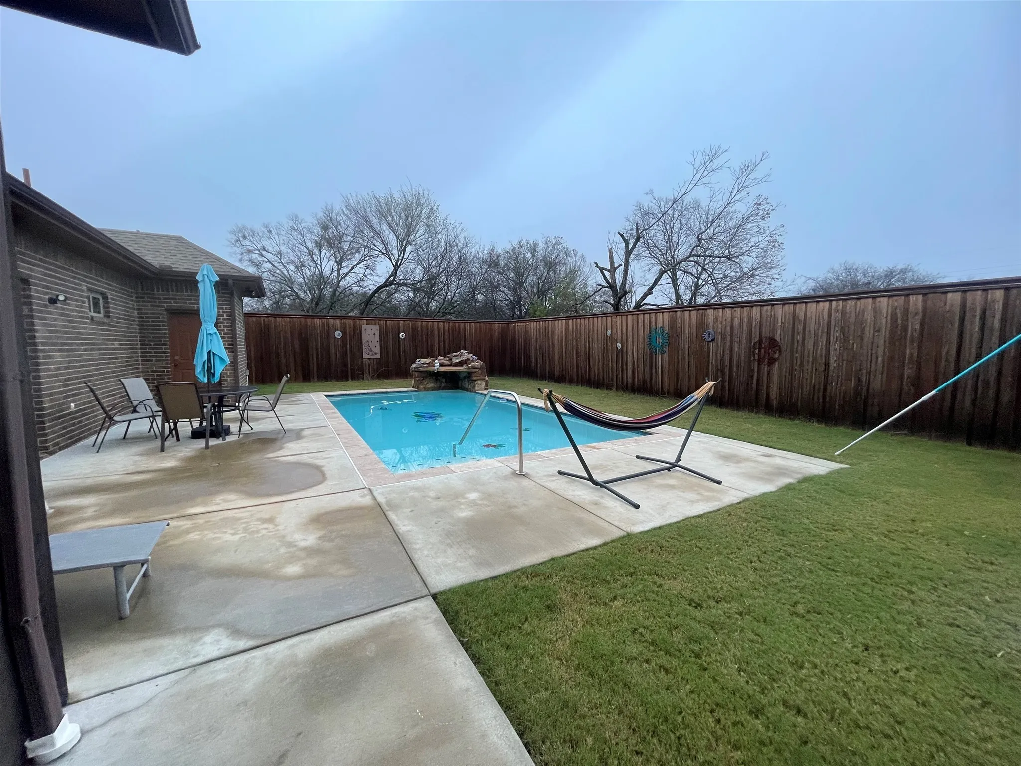 View of pool featuring a patio area and a fenced backyard