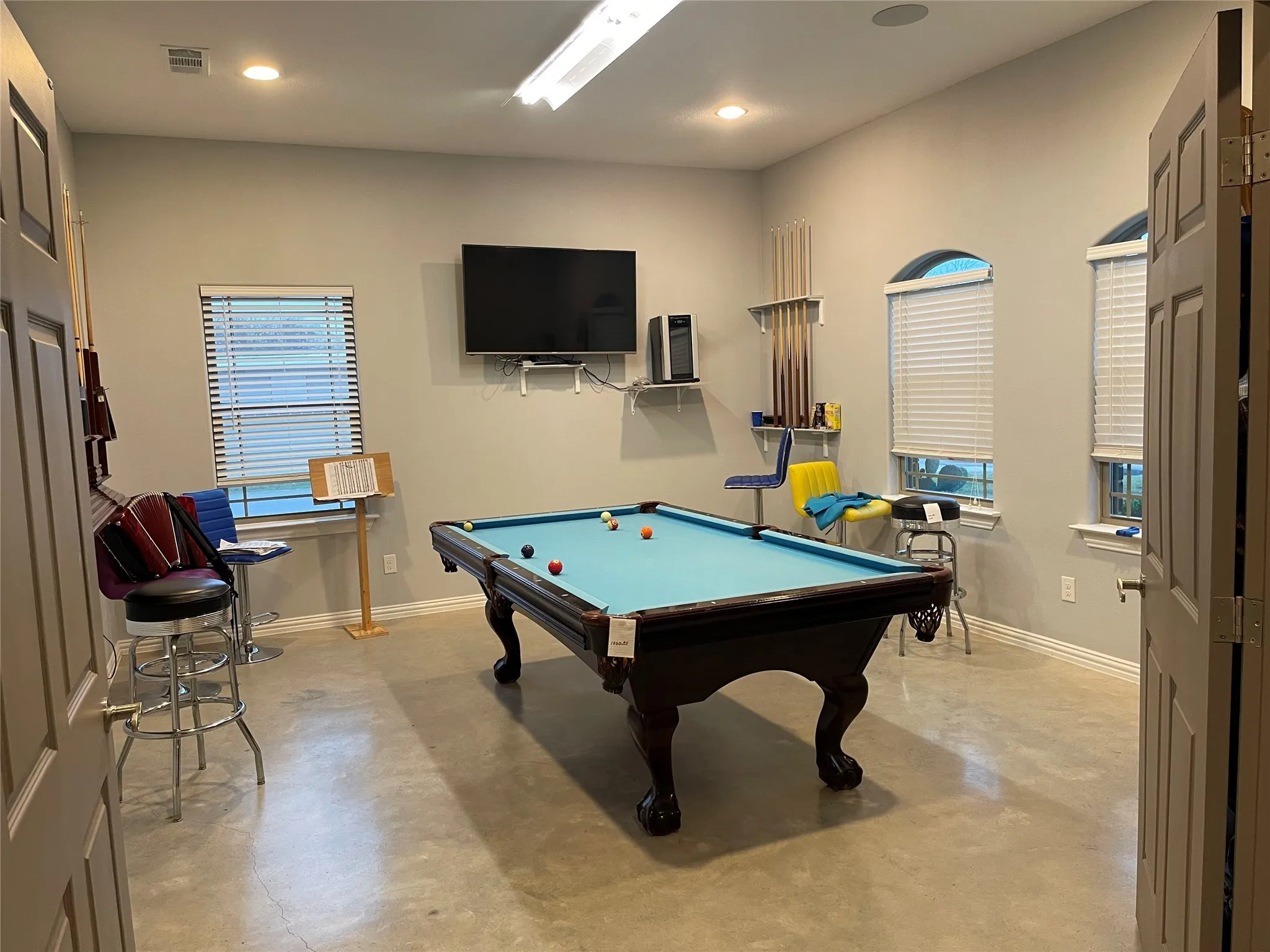 Rec room featuring pool table, finished concrete floors, and recessed lighting