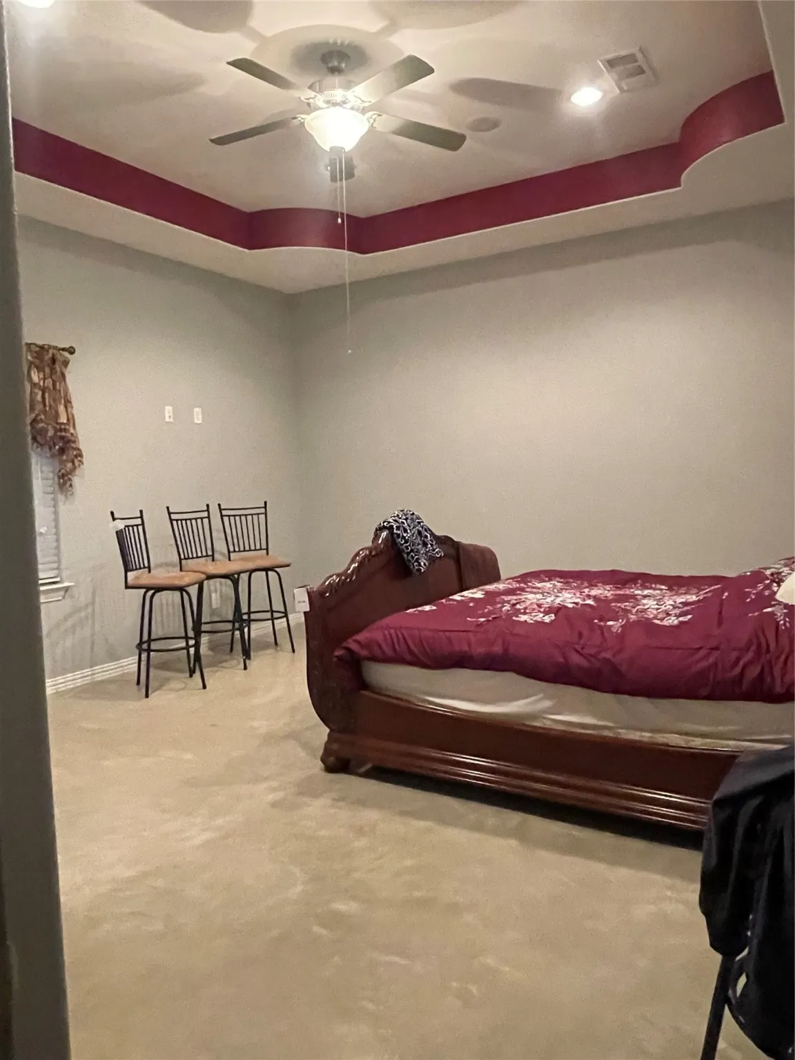 Bedroom with a tray ceiling, recessed lighting, and a ceiling fan