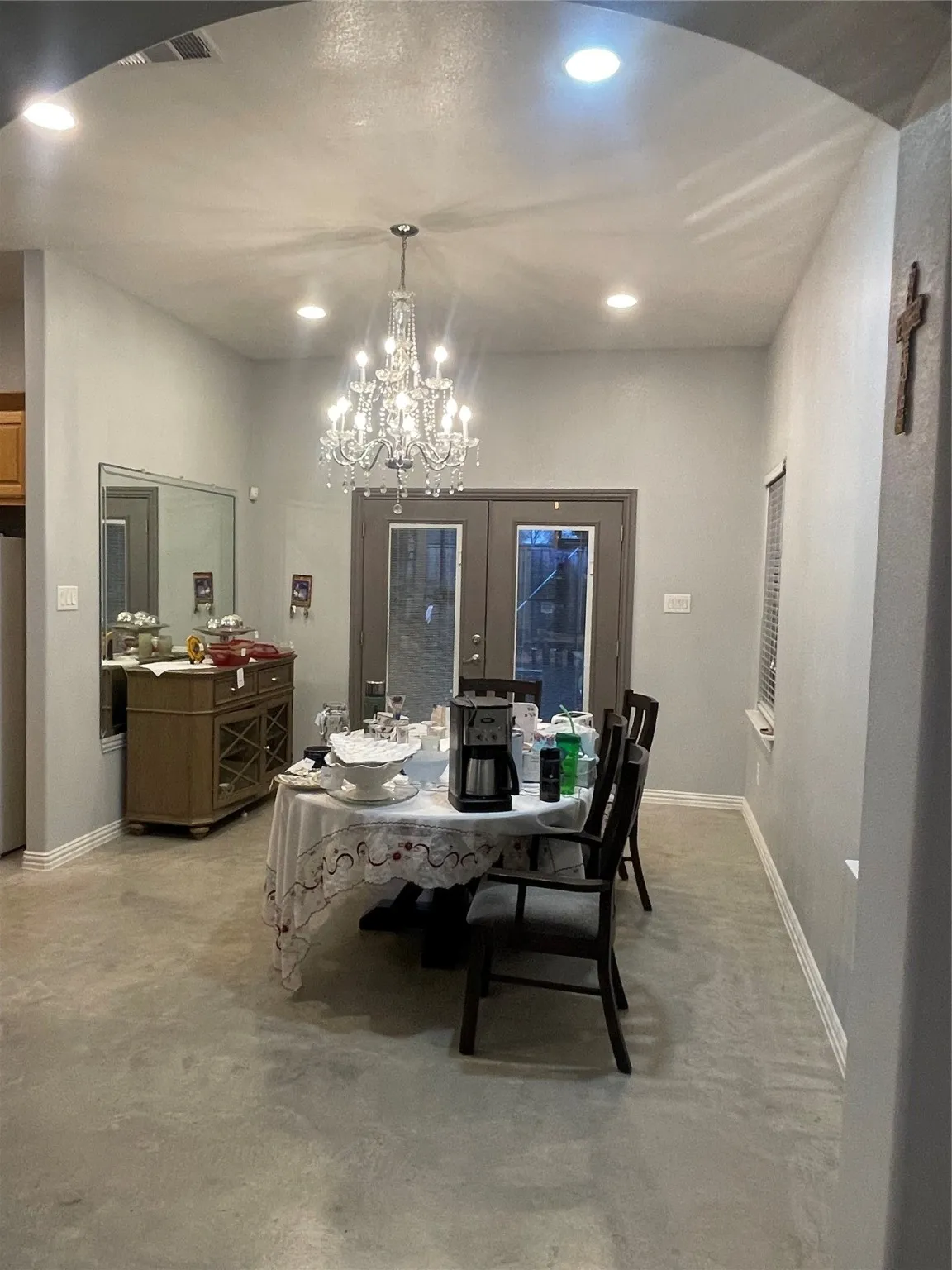 Dining space featuring recessed lighting, a chandelier, and concrete flooring
