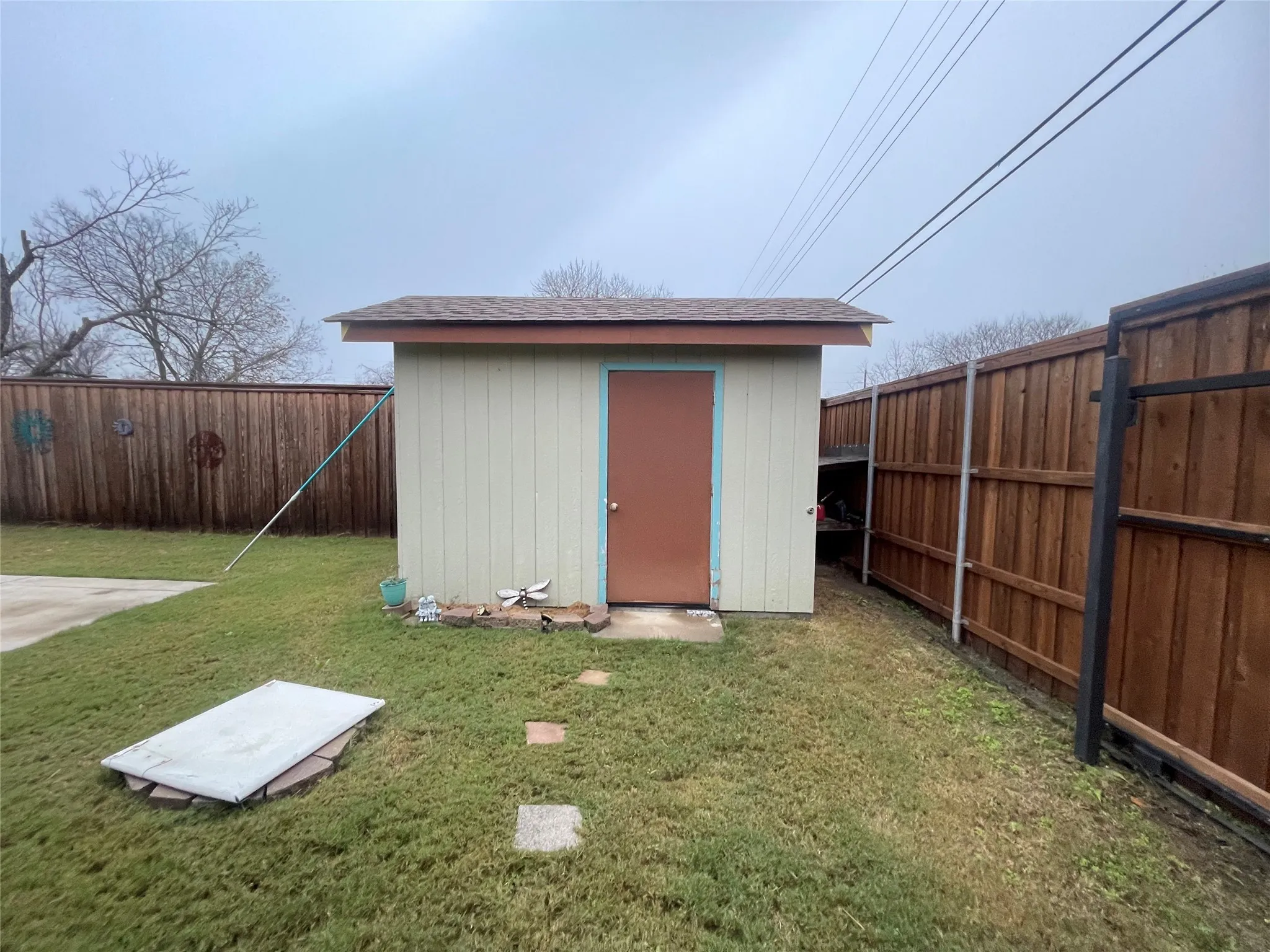 View of shed with a fenced backyard