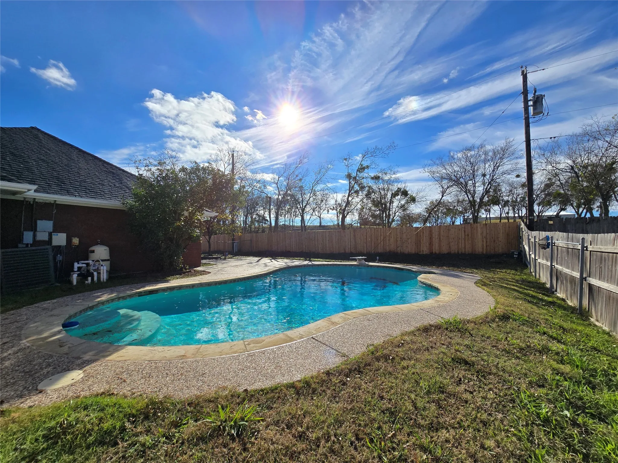 View of pool with a fenced backyard, a patio, and a diving board