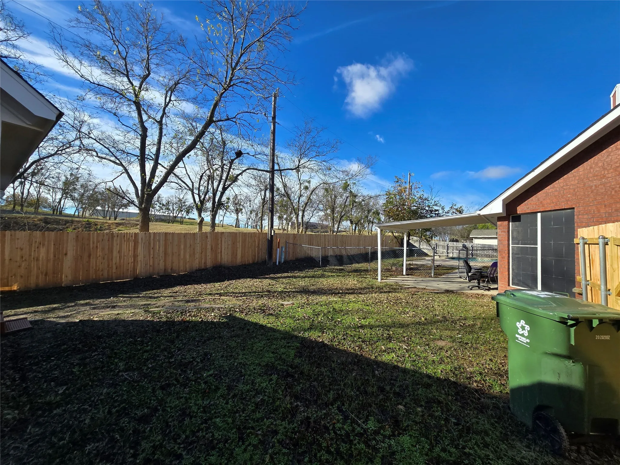 Fenced backyard with a patio area