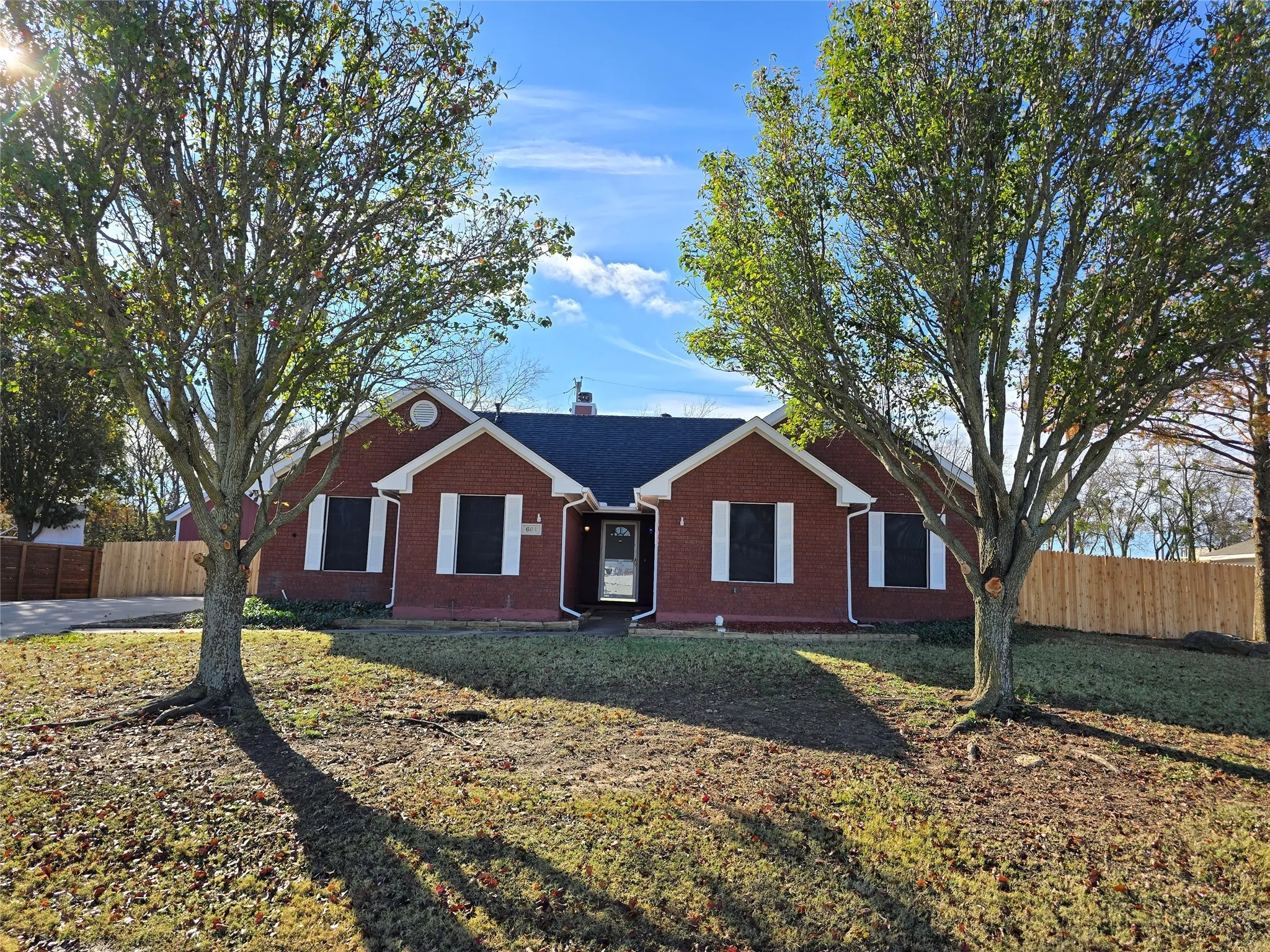 Single story home featuring brick siding and a chimney