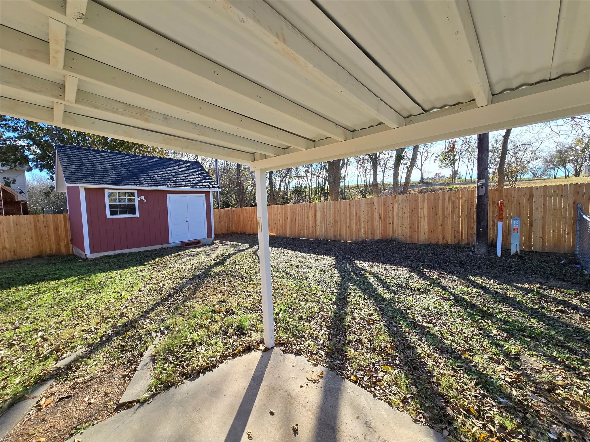Fenced backyard with a shed