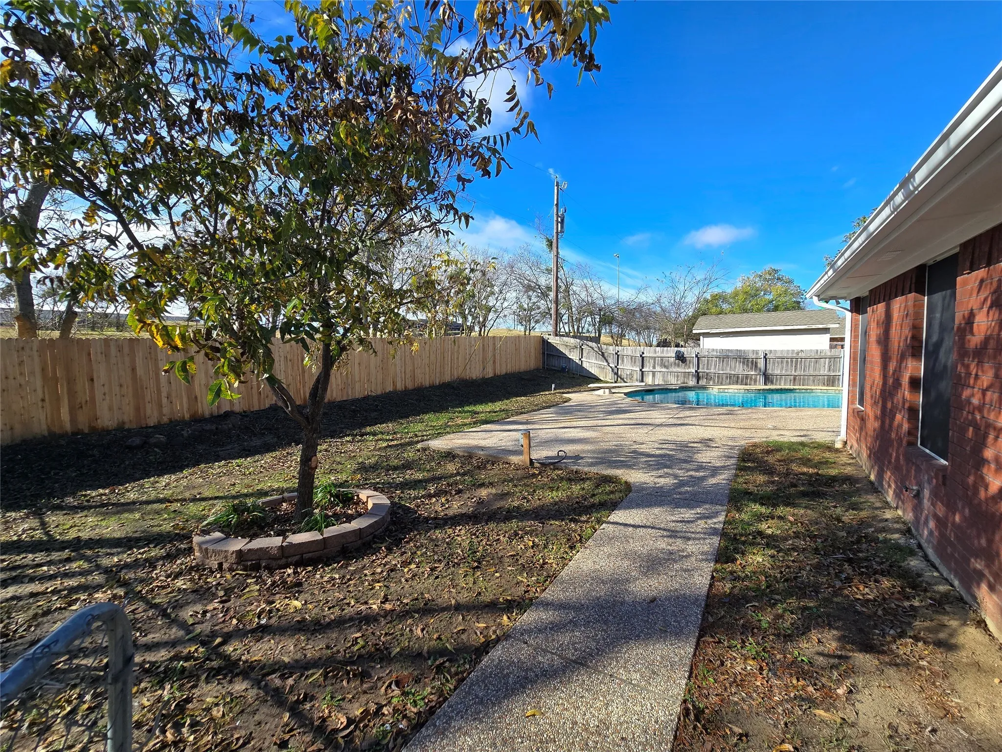 Fenced backyard with a patio