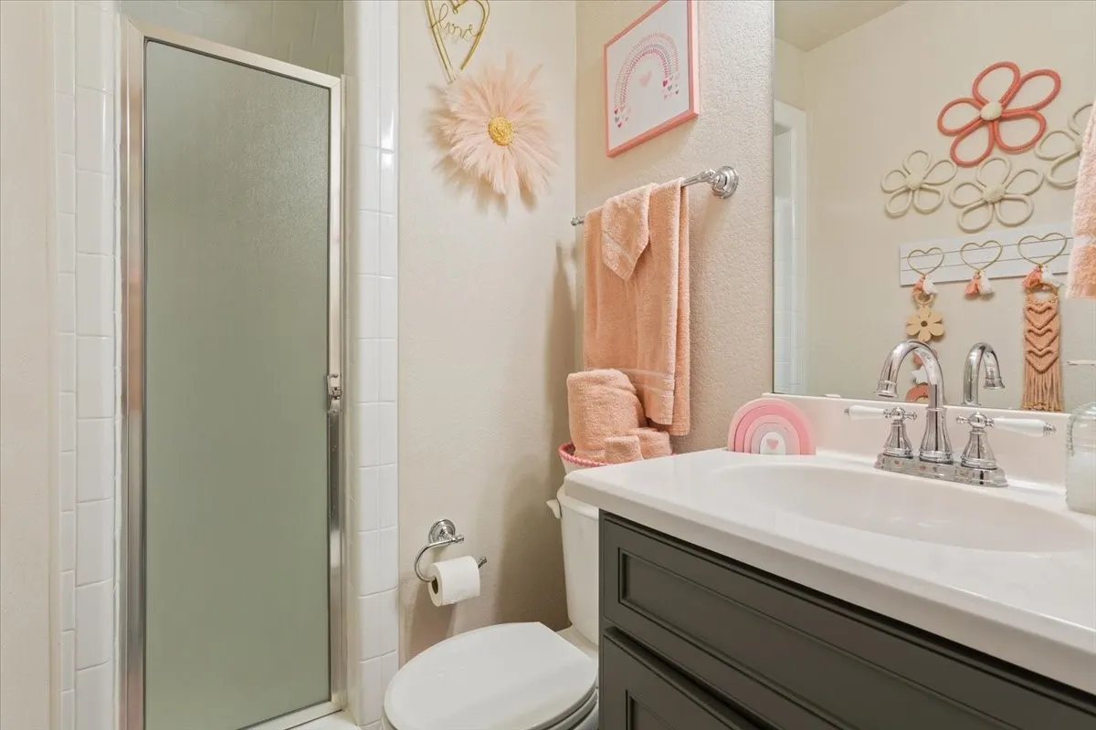 Bathroom featuring vanity and a shower stall