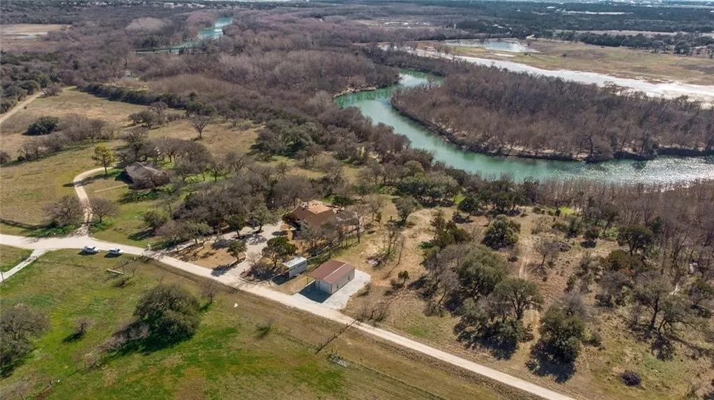 Aerial view of property and surrounding area with a large body of water