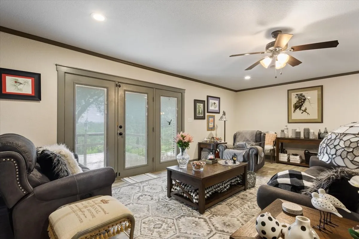 Living area with crown molding, french doors, recessed lighting, and a ceiling fan