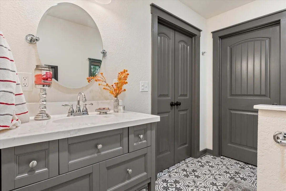 Bathroom with vanity and a textured wall