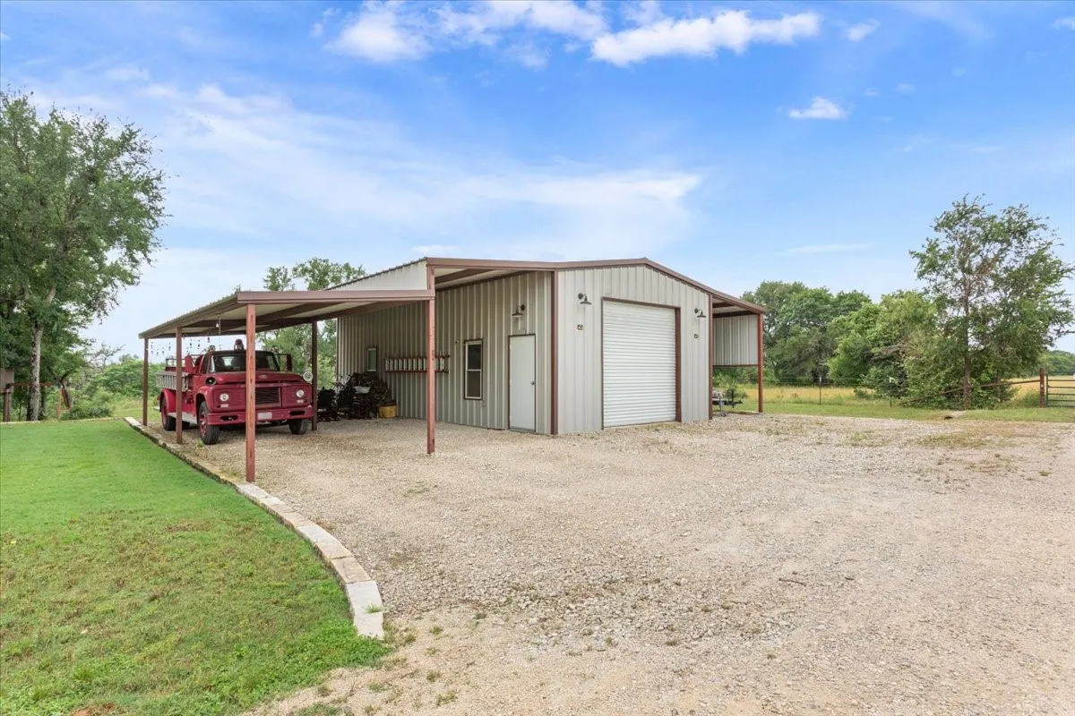 Garage featuring a garage and driveway