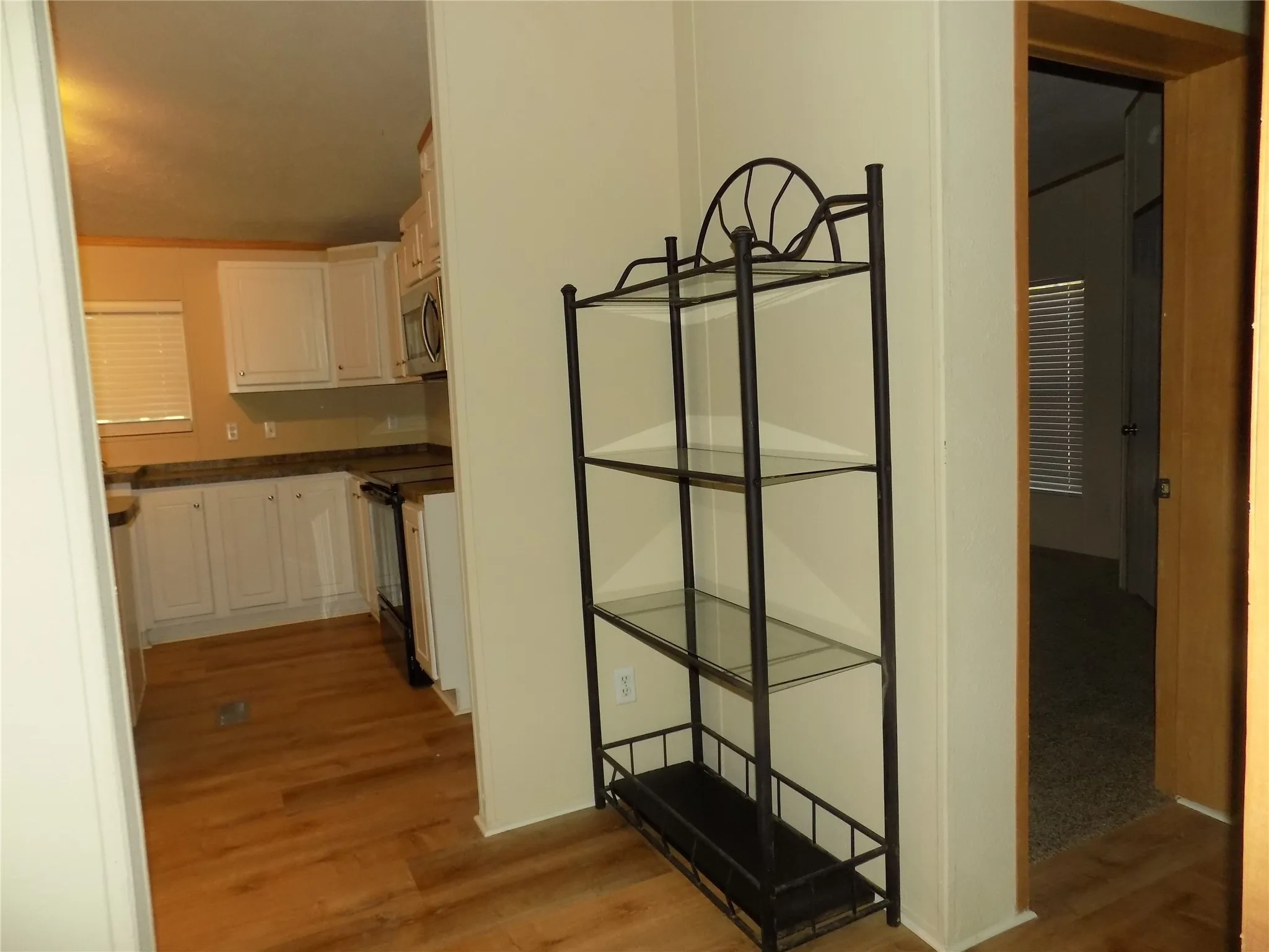 Entry from kitchen to other rooms in the home, with lovely extra decorative shelves.