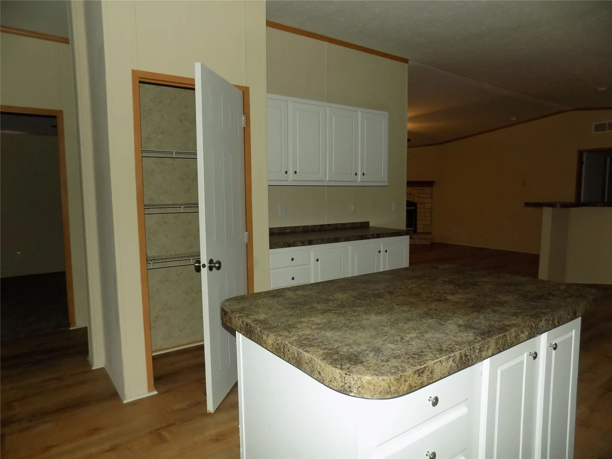 Closer picture of extra cabinets, pantry and kitchen island.