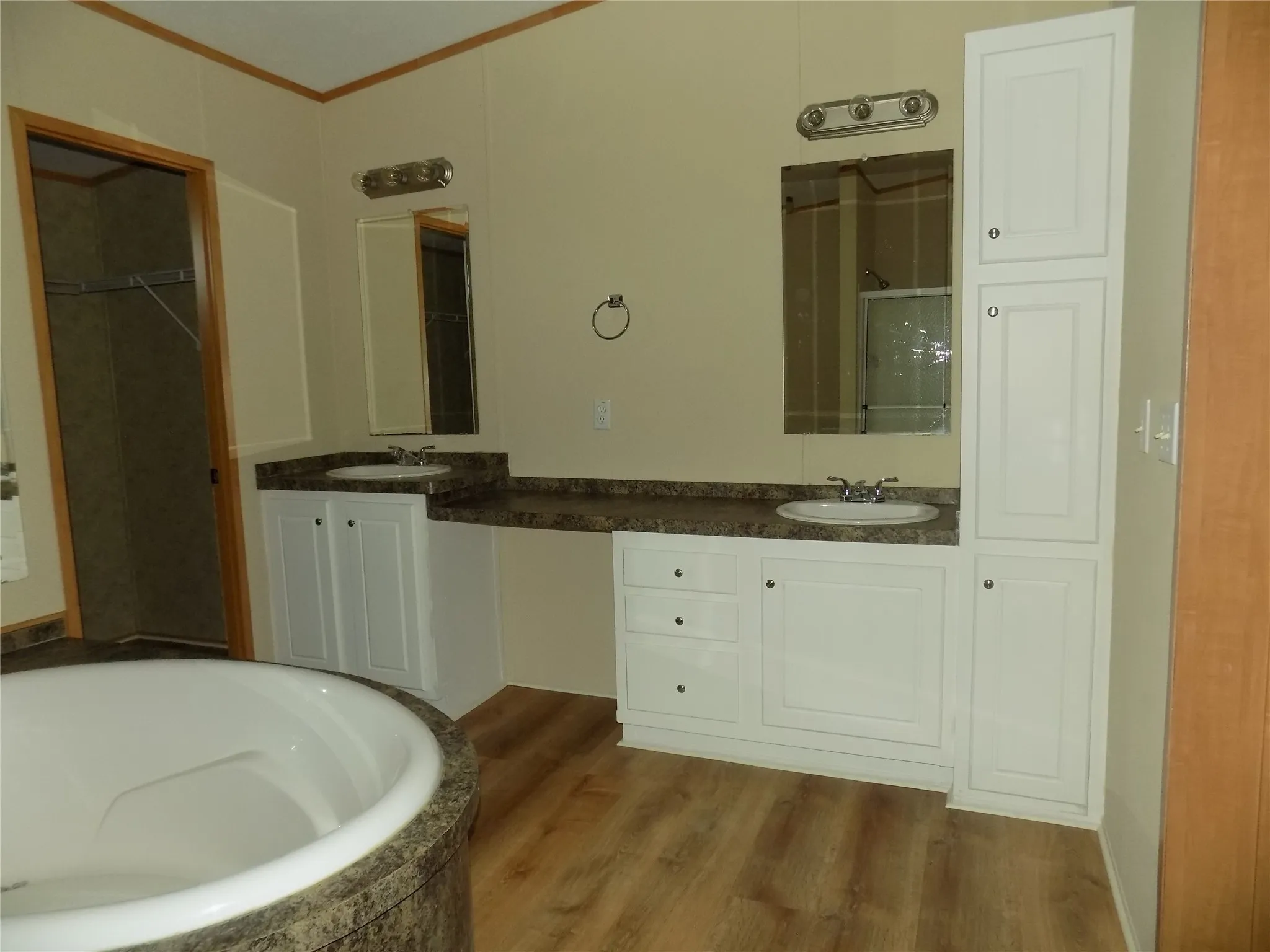Wonderfully large primary bathroom with garden tub, dual sinks, extra space for a stool, linen closest and walk-in closet. The shower is separate.