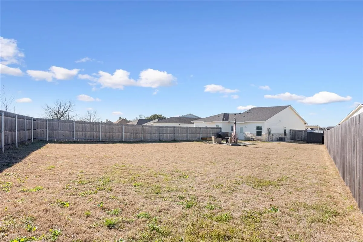 Fenced backyard featuring a patio area