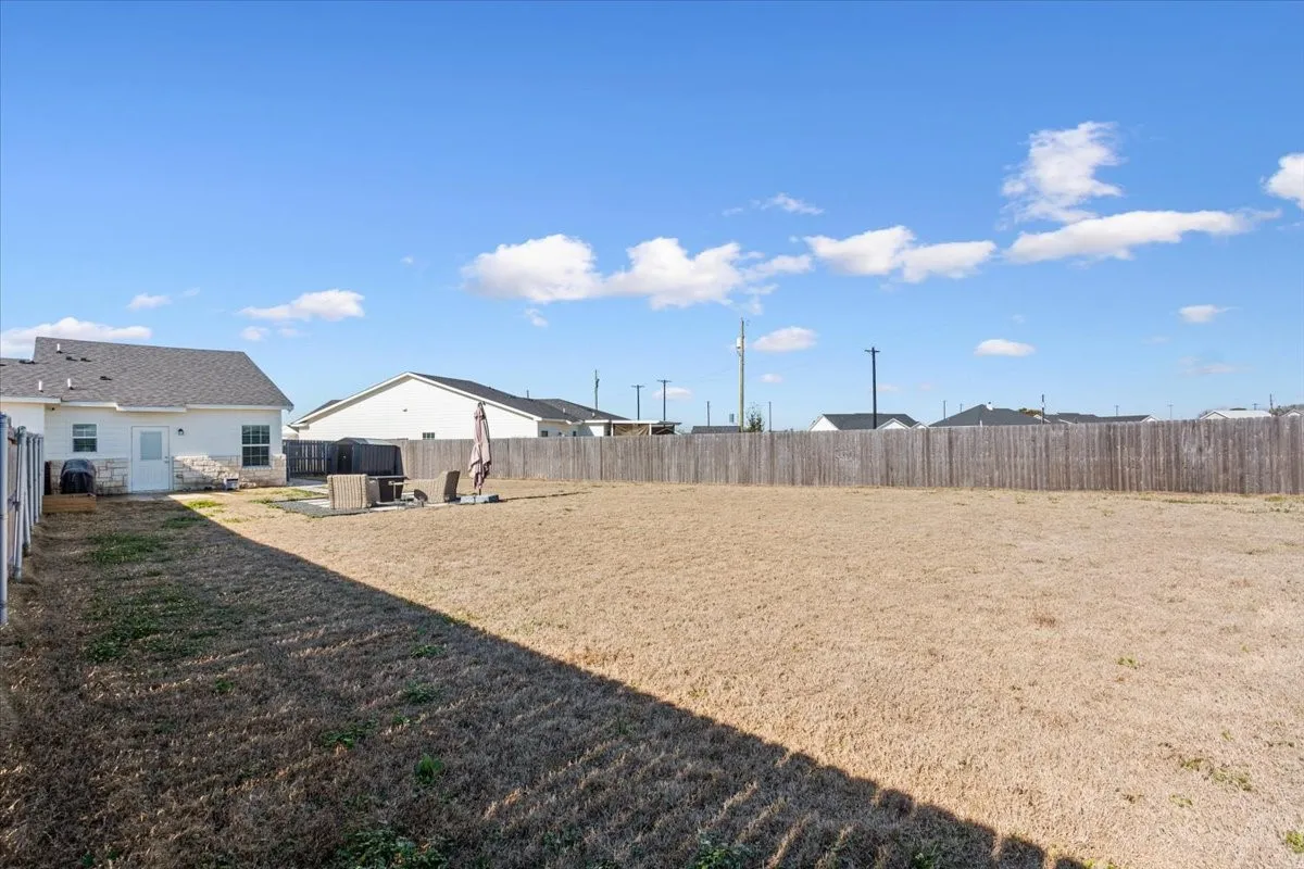 View of fenced backyard