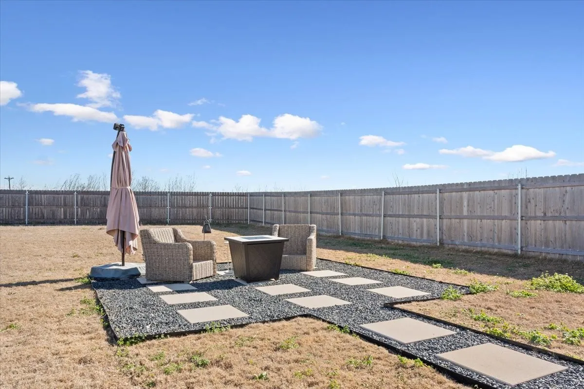 Fenced backyard with a patio