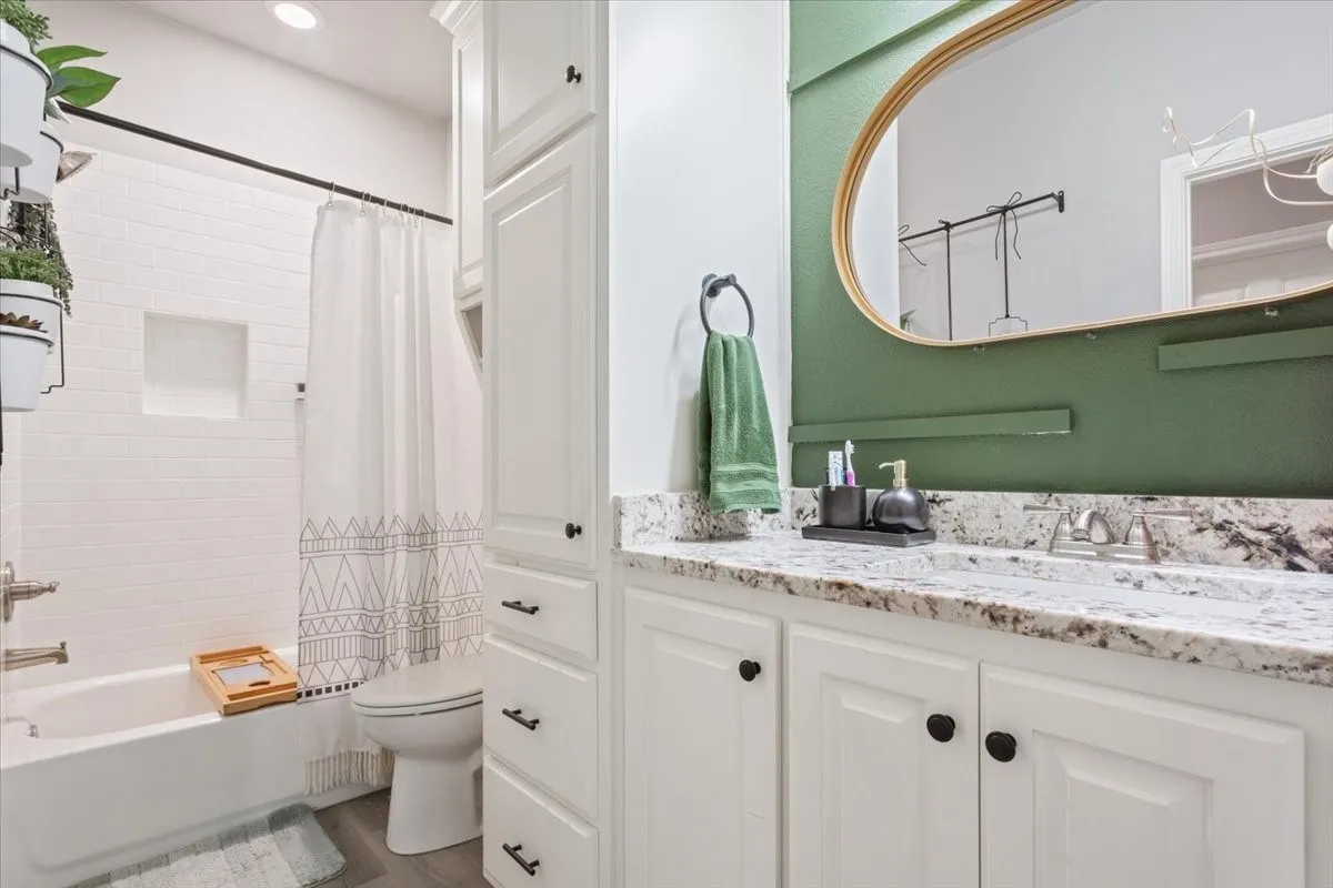 Bathroom with vanity and shower / tub combo